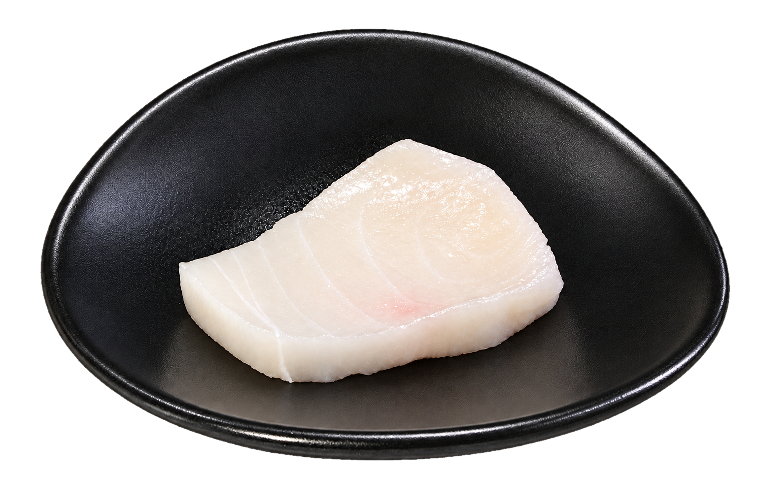 A piece of raw white fish, possibly cod or halibut, on a black plate.