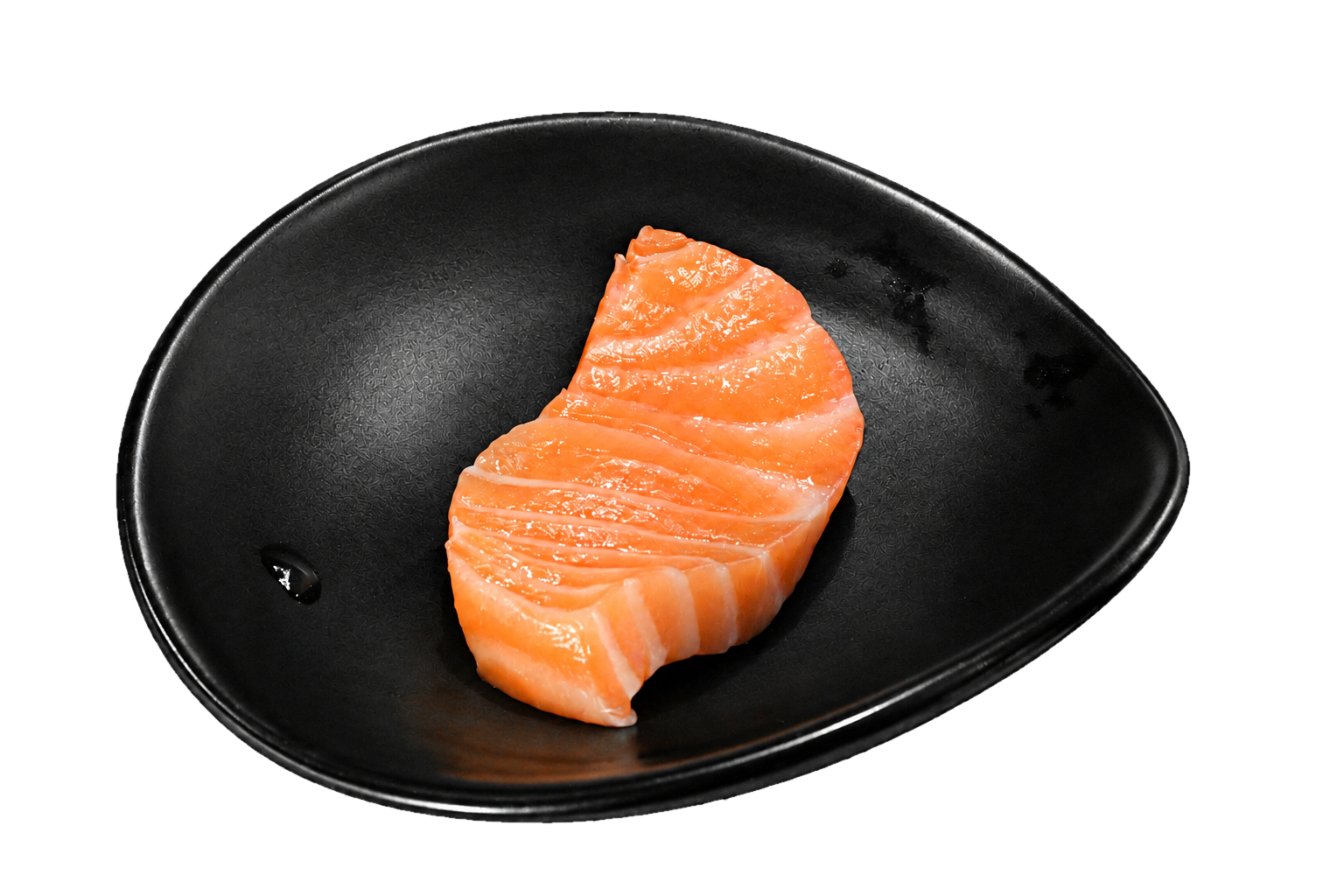 Raw slice of salmon fish on a black dish.