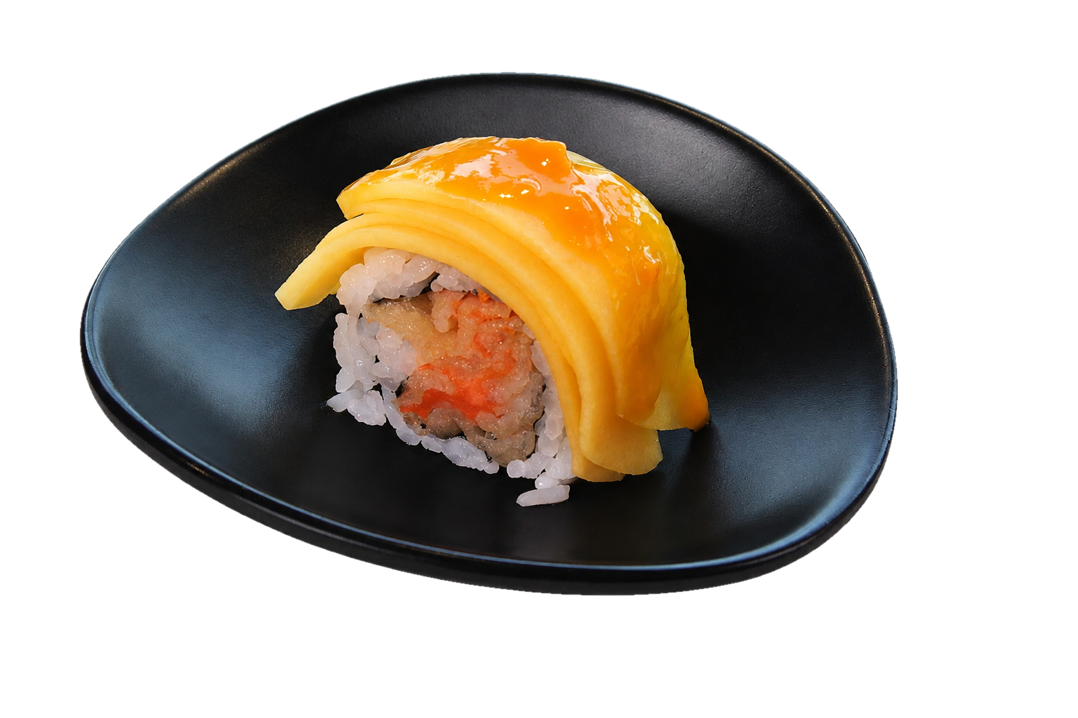 Sushi roll with mango slices and orange glaze on top, served on a black plate.