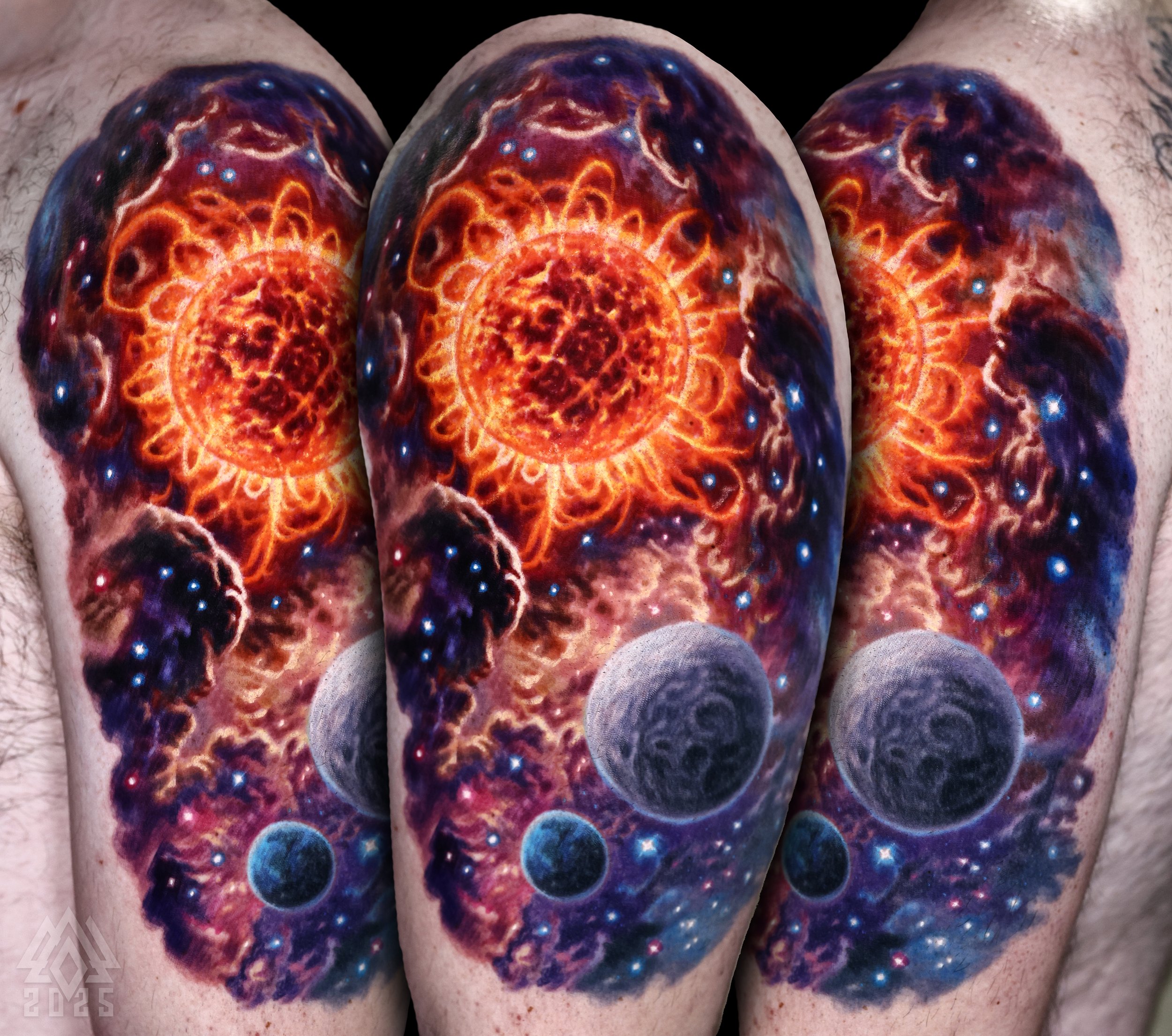 Colorful tattoo of a cosmic, galaxy-themed design covering the upper arm, featuring swirling patterns, stars, and fiery orange and purple hues.