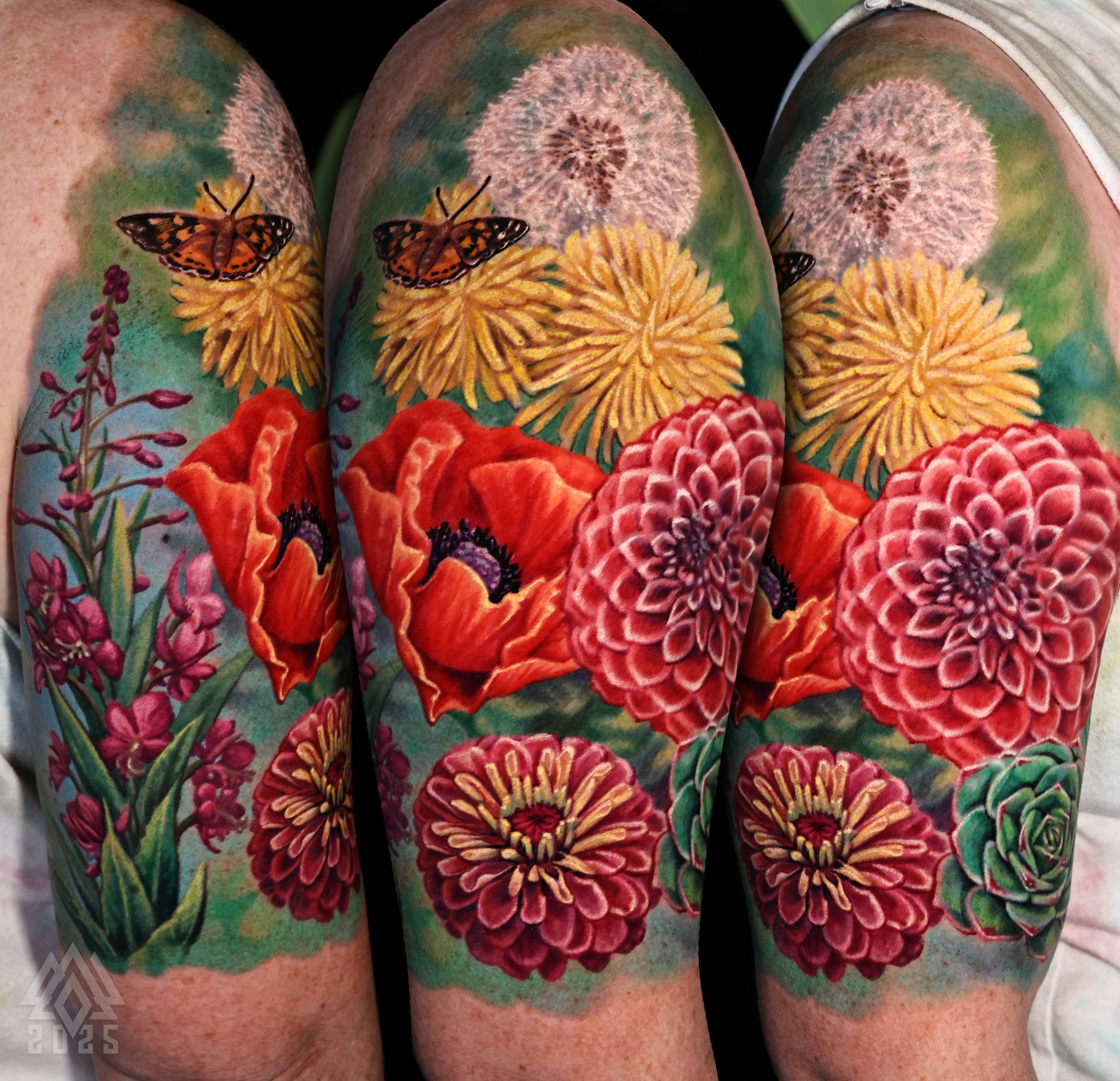 Close-up of a tattoo featuring orange butterflies, yellow flowers, and red roses on a person's arm.