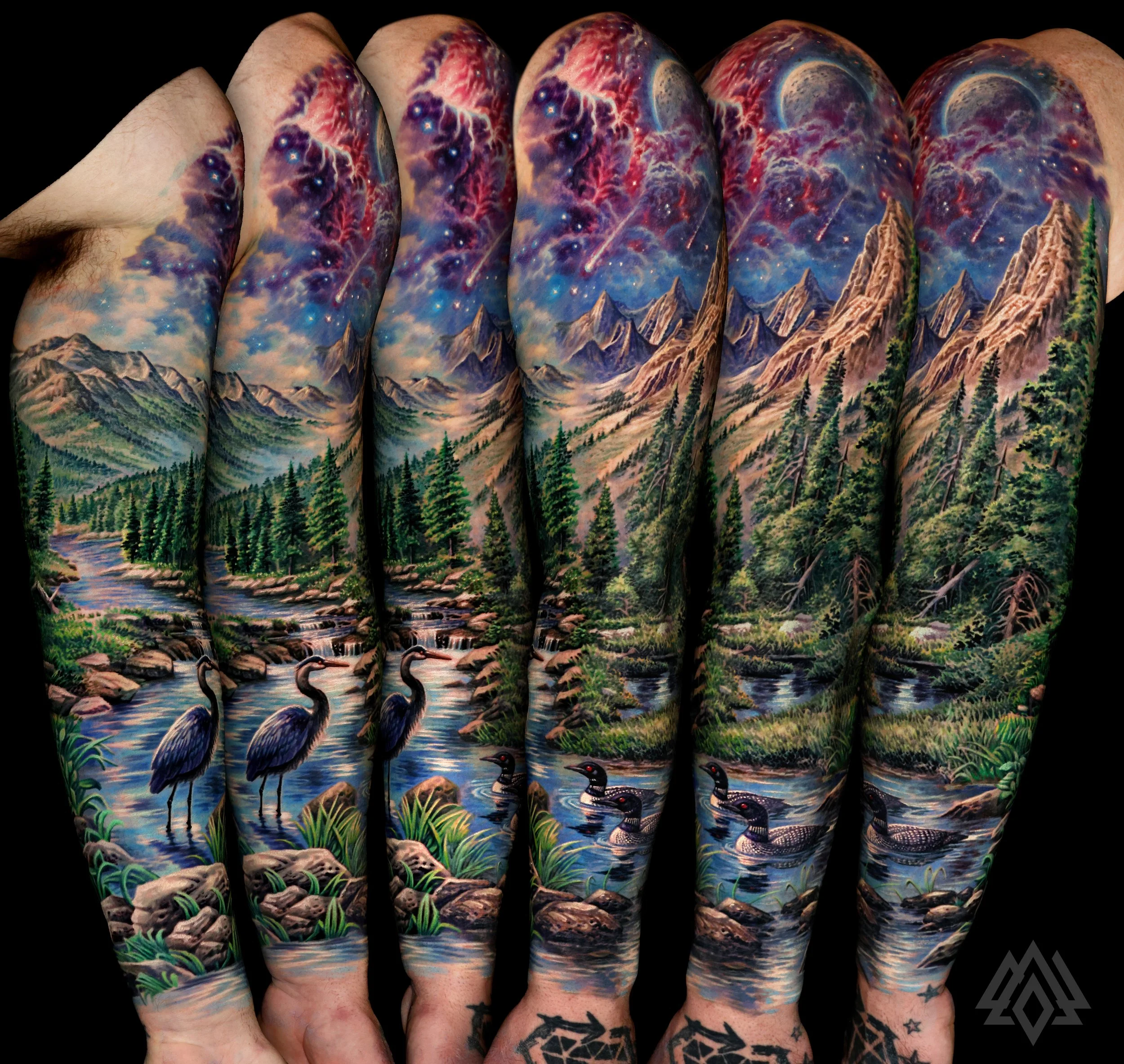 Colorful tattoo sleeve depicting mountains, pine trees, a river, and a sky with shooting stars and nebulae on a person's arm.