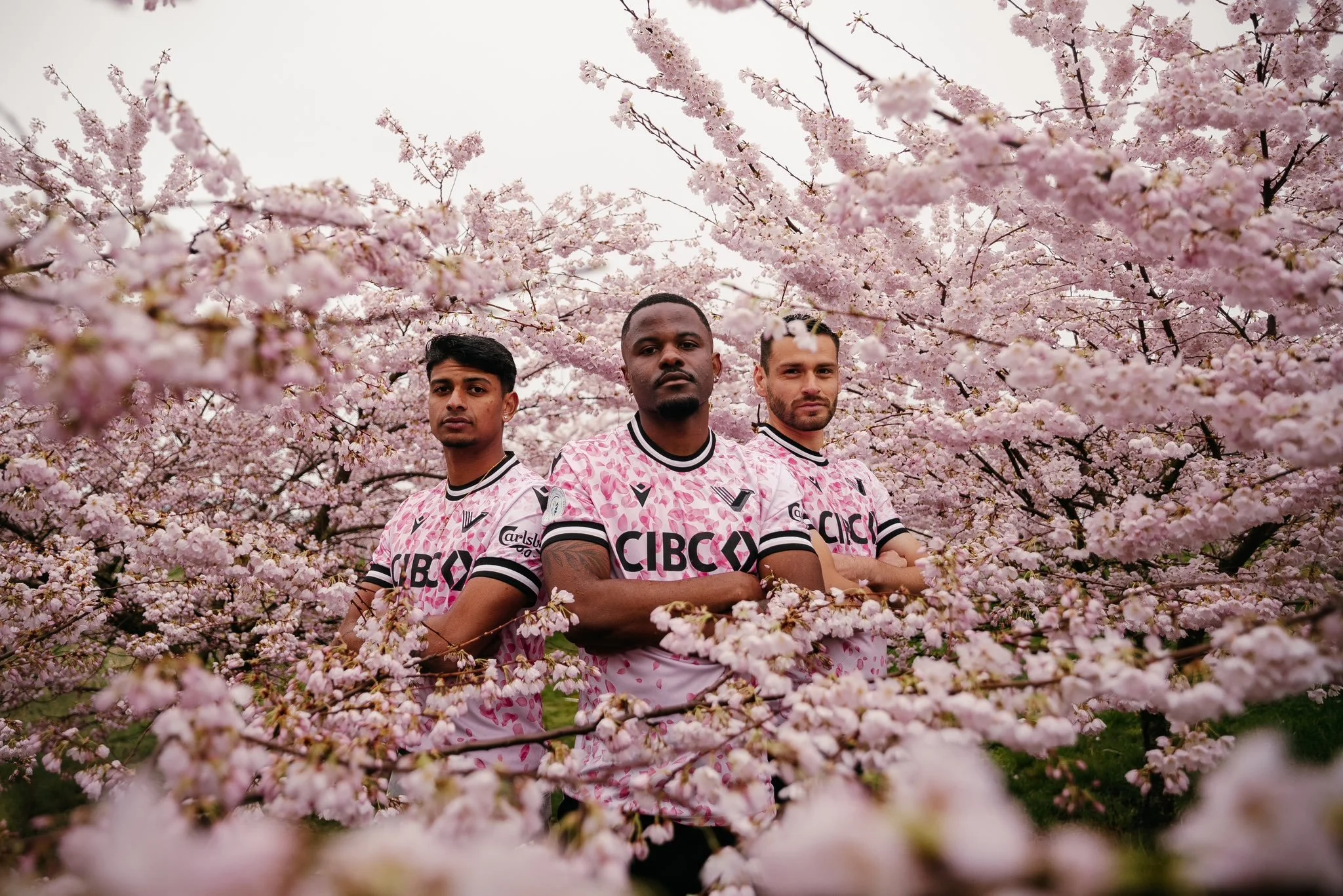 	
Beau Chevalier photo of Kembo Kibato, Zach Verhoven, and Alejandro Diaz posing in Vancouver FC's famous 2024 Cherry Blossom Kit