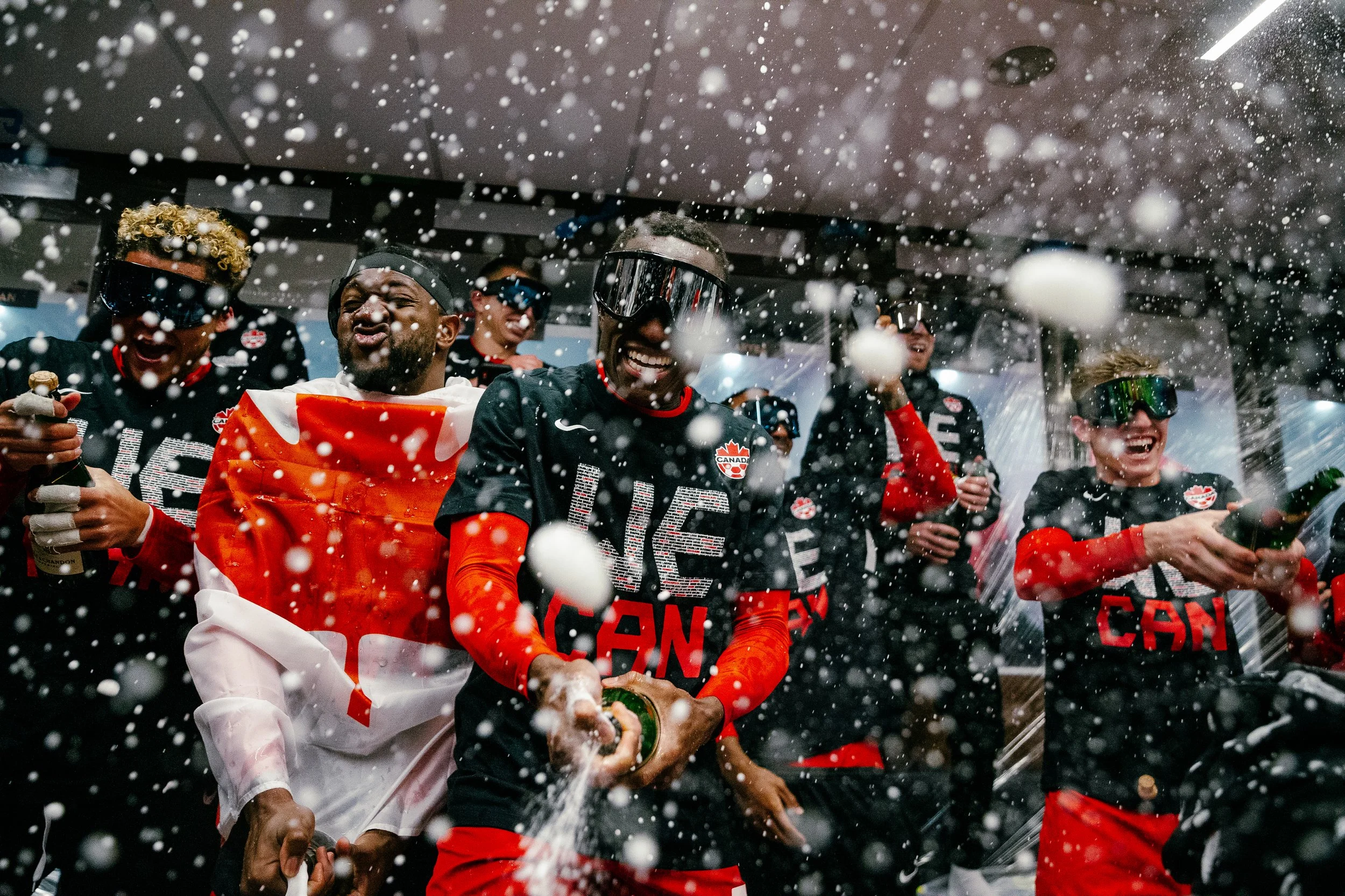 	
Beau Chevalier photo of Canada Soccer players celebrating in the locker room after qualifying for the 2022 FIFA World Cup in Qatar.