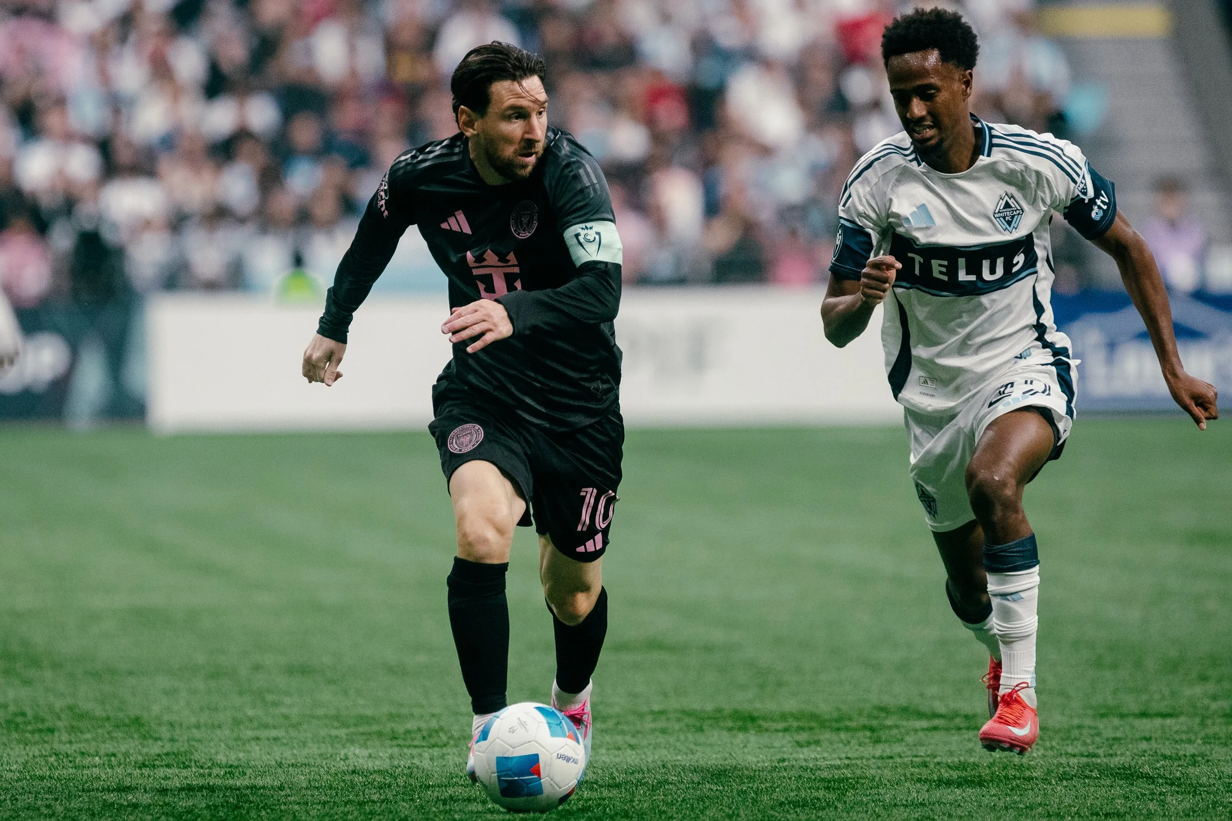 Beau Chevalier photo of soccer player Lionel Messi playing against Vancouver Whitecaps FC player Ali Ahmed at BC Place in 2025 Concacaf Champions Cup tournament