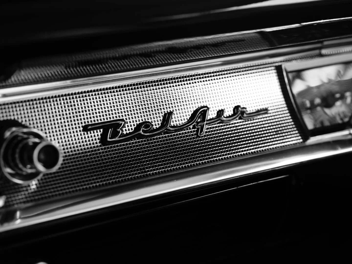 Close-up of a vintage car radio with the word 'Beetle' on the front grille in black and white.
