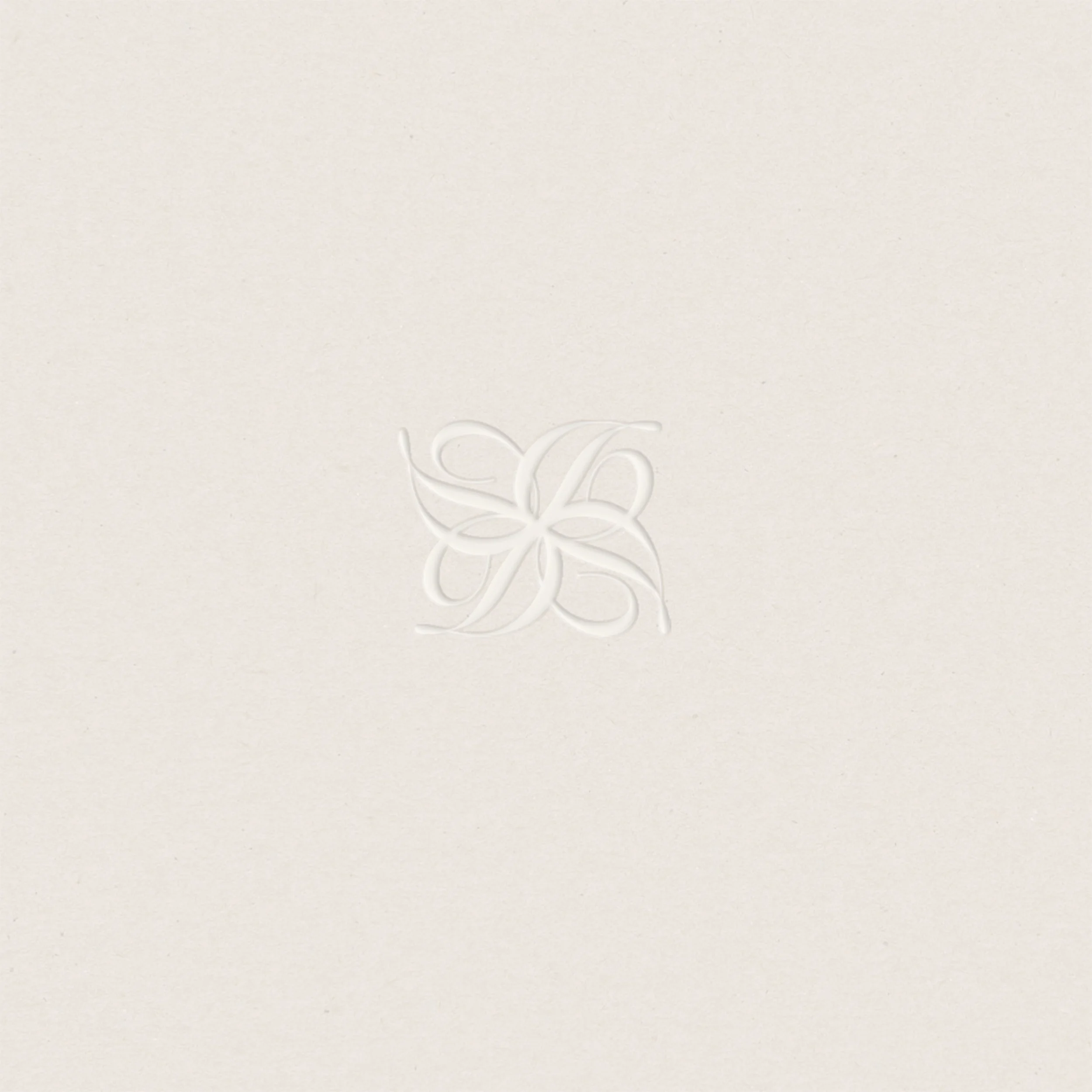 Close-up of a textured, cream-colored surface with embossed cursive lettering.