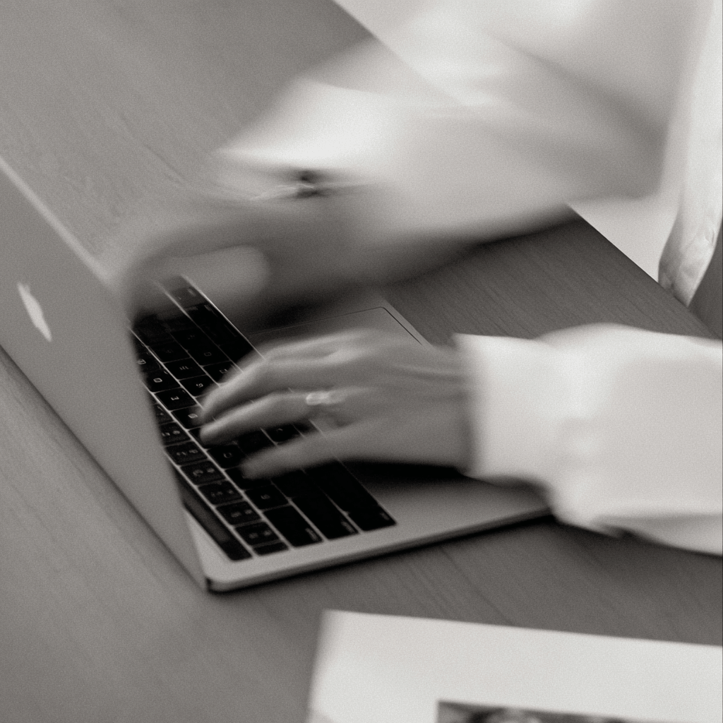 designer typing on laptop