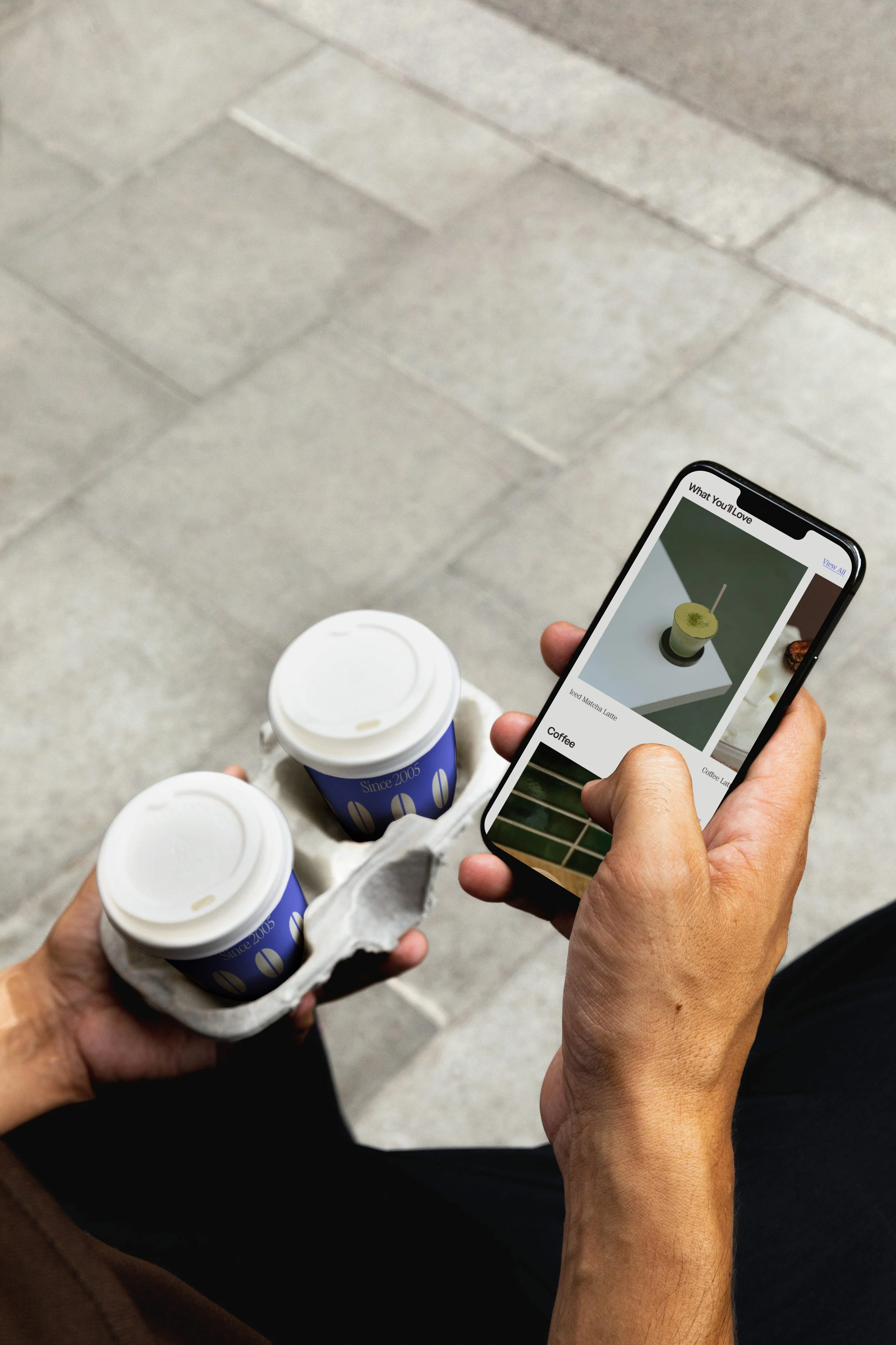 mobile mockup holding cup of coffee