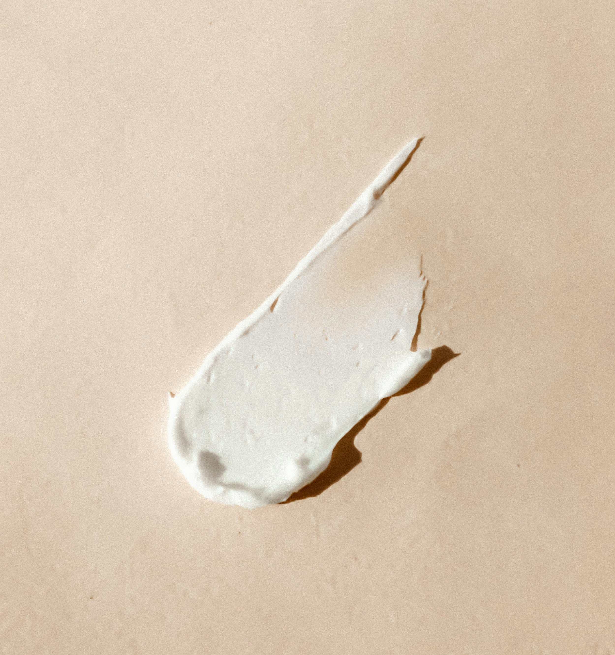 Close-up of a tear in white paper with a brownish streak visible inside the tear.