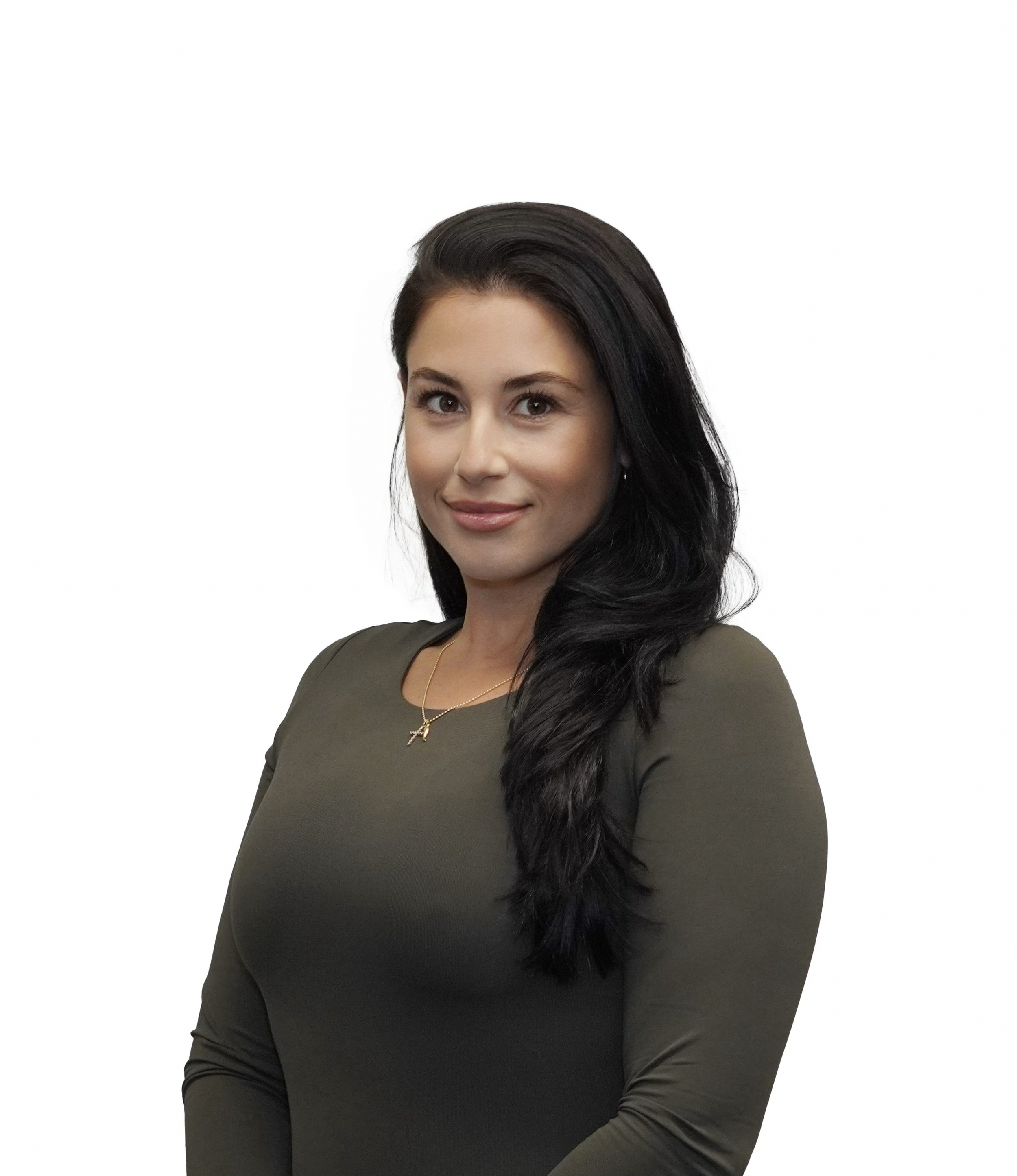 A woman with long dark hair wearing an olive green top and a gold necklace with a cross pendant, smiling slightly against a plain white background.