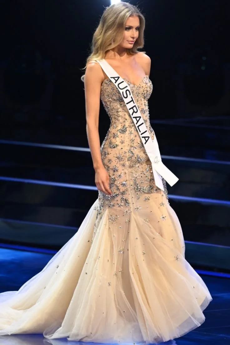 Miss Australia wearing an embellished evening gown and sash during a beauty pageant.