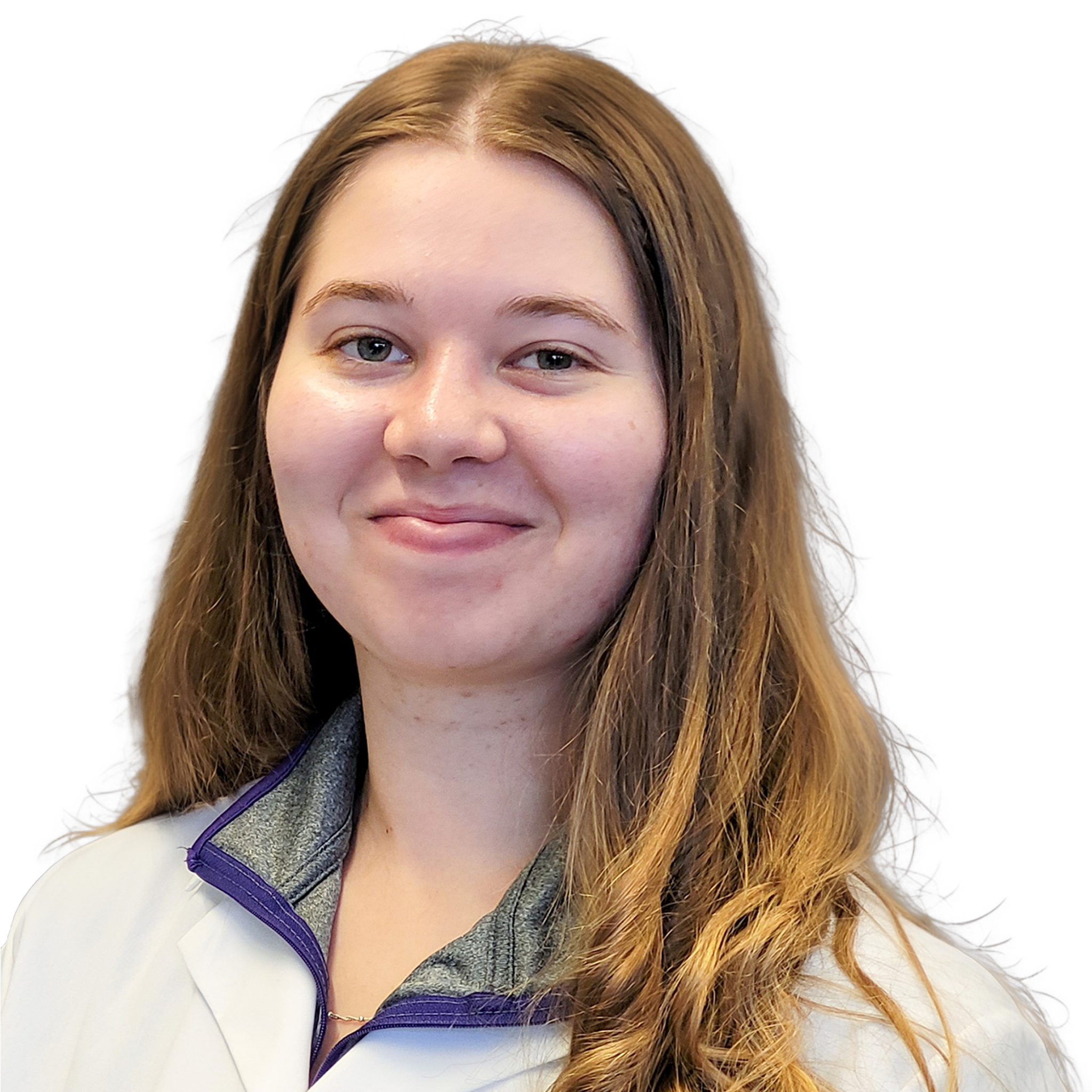 Close-up of a woman with long, wavy blonde hair wearing a white and gray zip-up jacket with purple accents, smiling slightly against a plain white background.