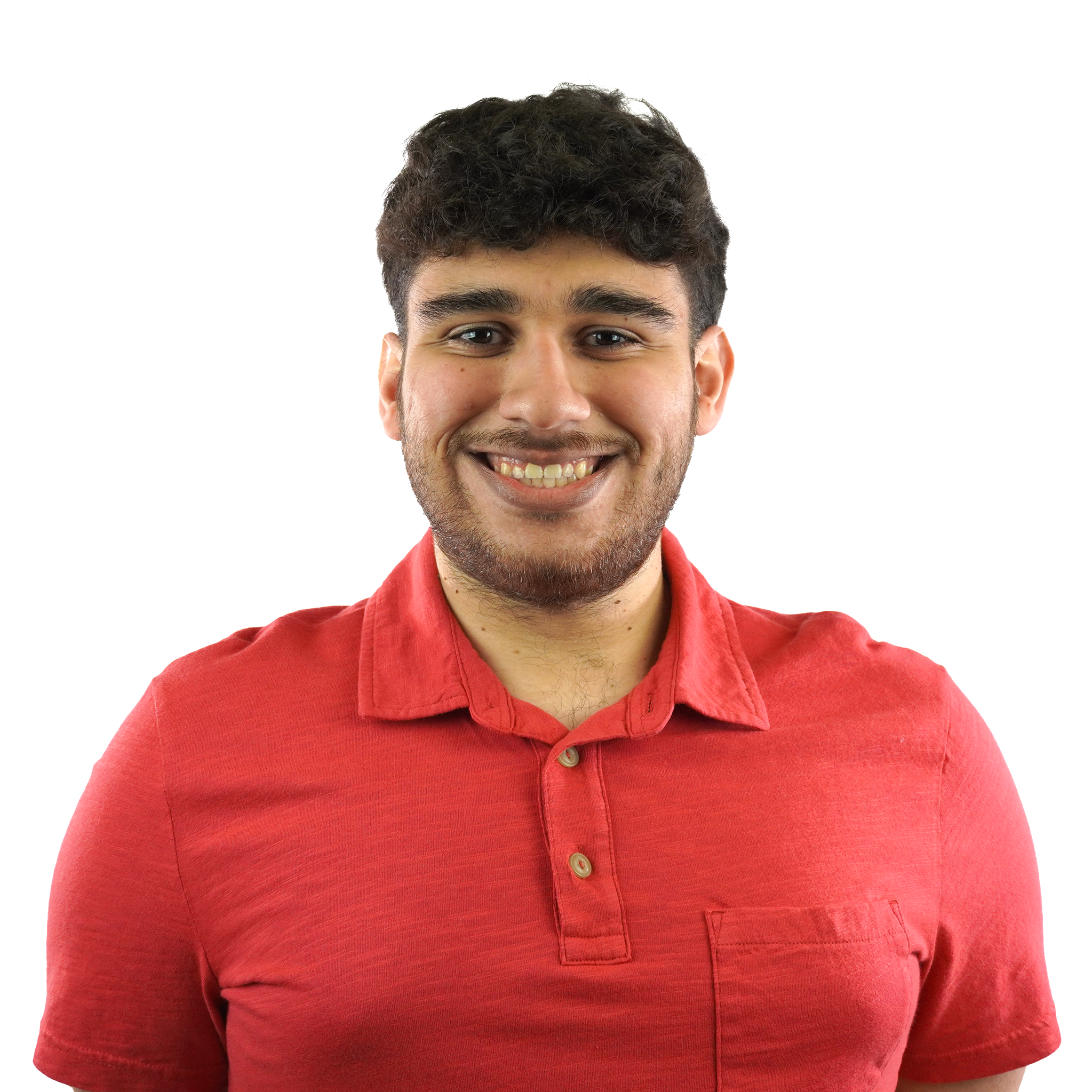 Close-up of a young man with dark, curly hair, smiling, wearing a red collared shirt against a plain white background.