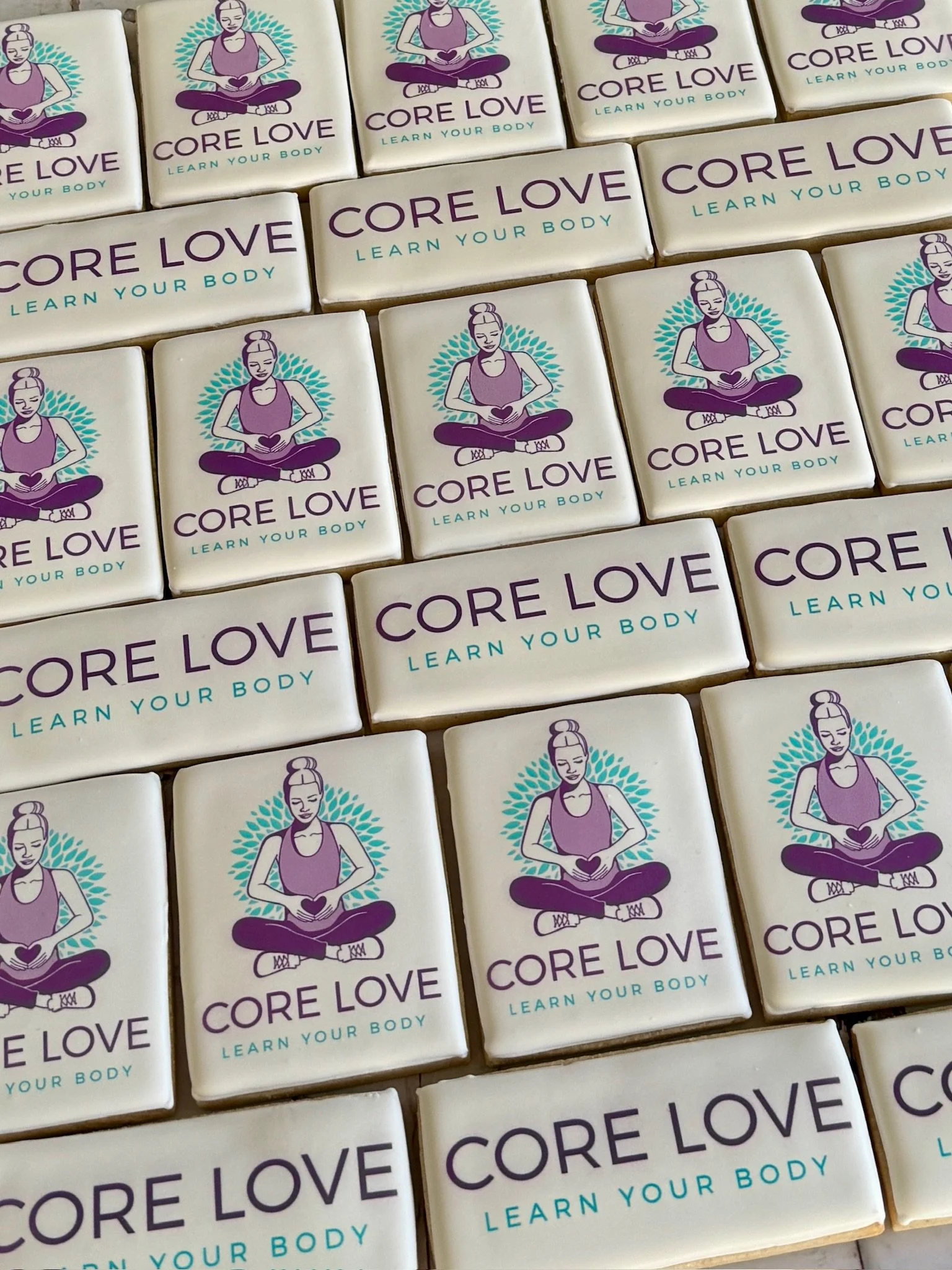 Pattern of white cards featuring a woman meditating with the message “CORE LOVE” and “LEARN YOUR BODY.”