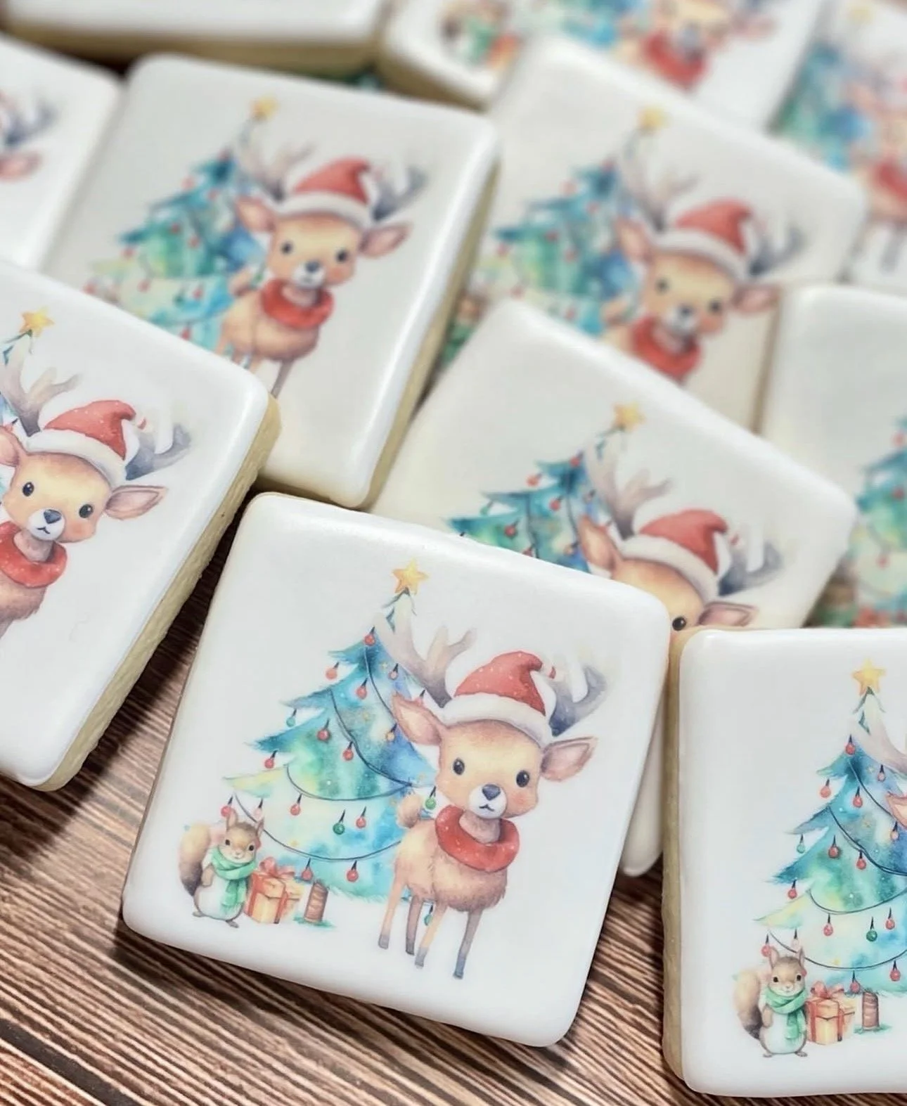 Stacked square Christmas coasters featuring a cute reindeer in a Santa hat beside a decorated Christmas tree
