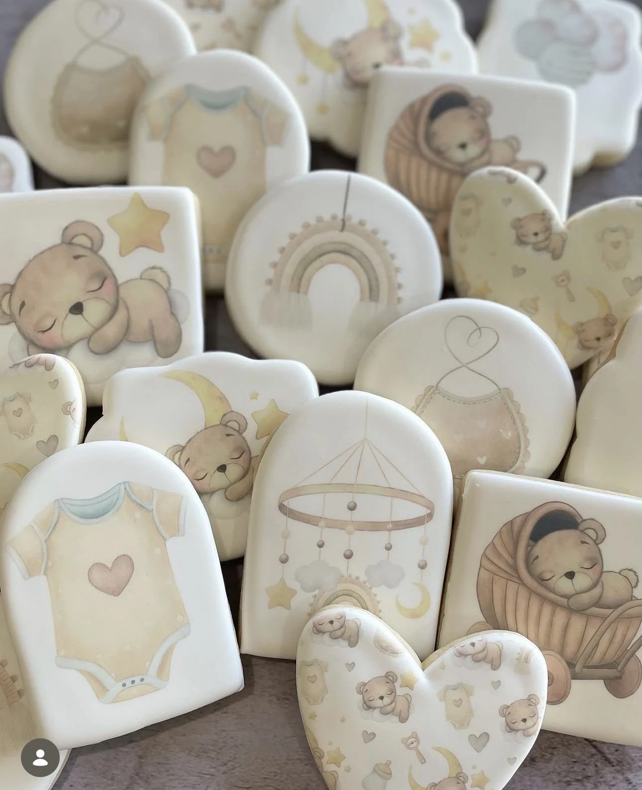 Collection of pastel baby-themed ceramic plates featuring teddy bears, onesies, rainbows, moons, stars, and nursery mobiles