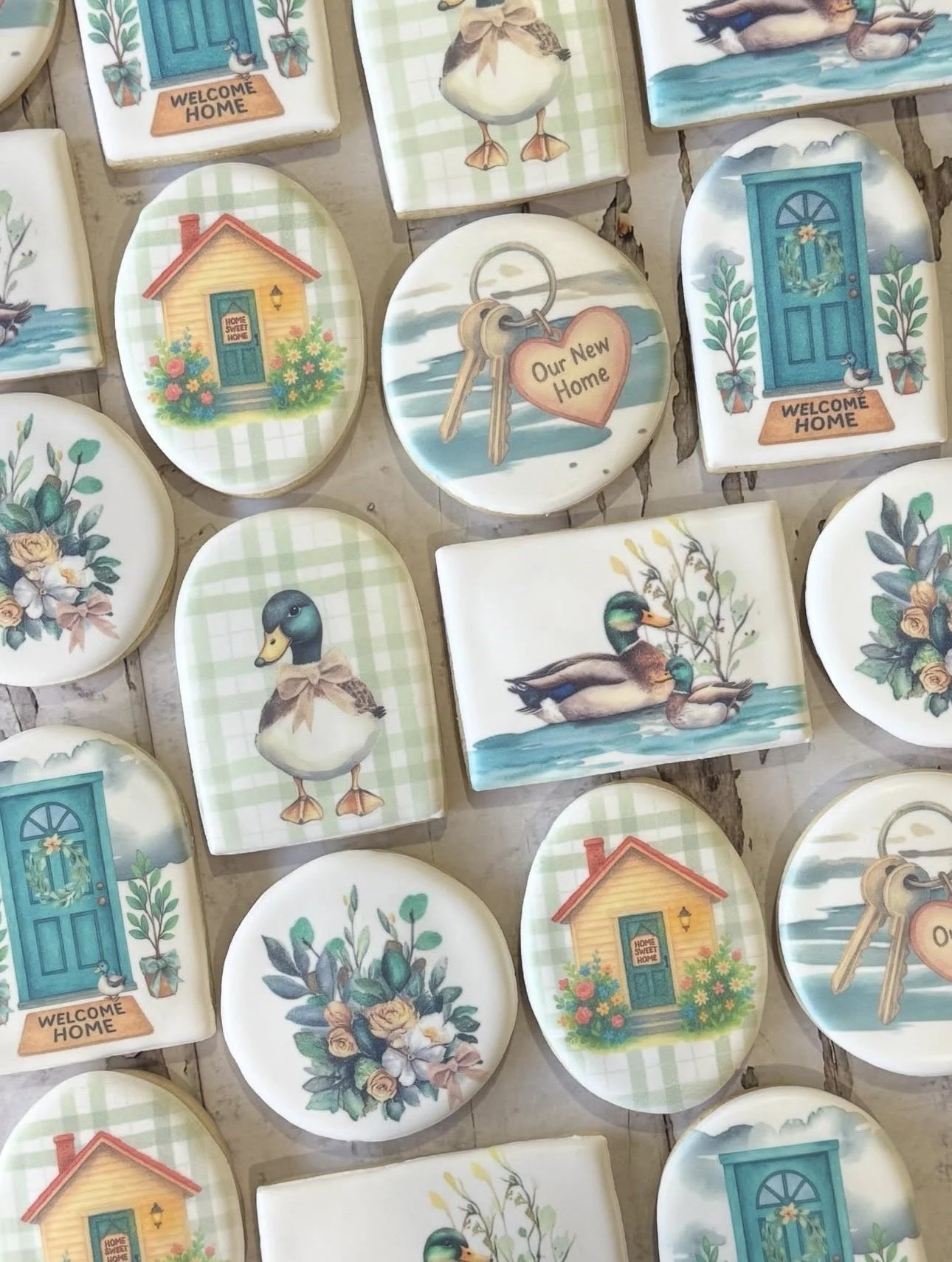 Decorative ceramic plates featuring welcome-home doors, ducks, flowers, houses, and keys labeled “Our New Home.”