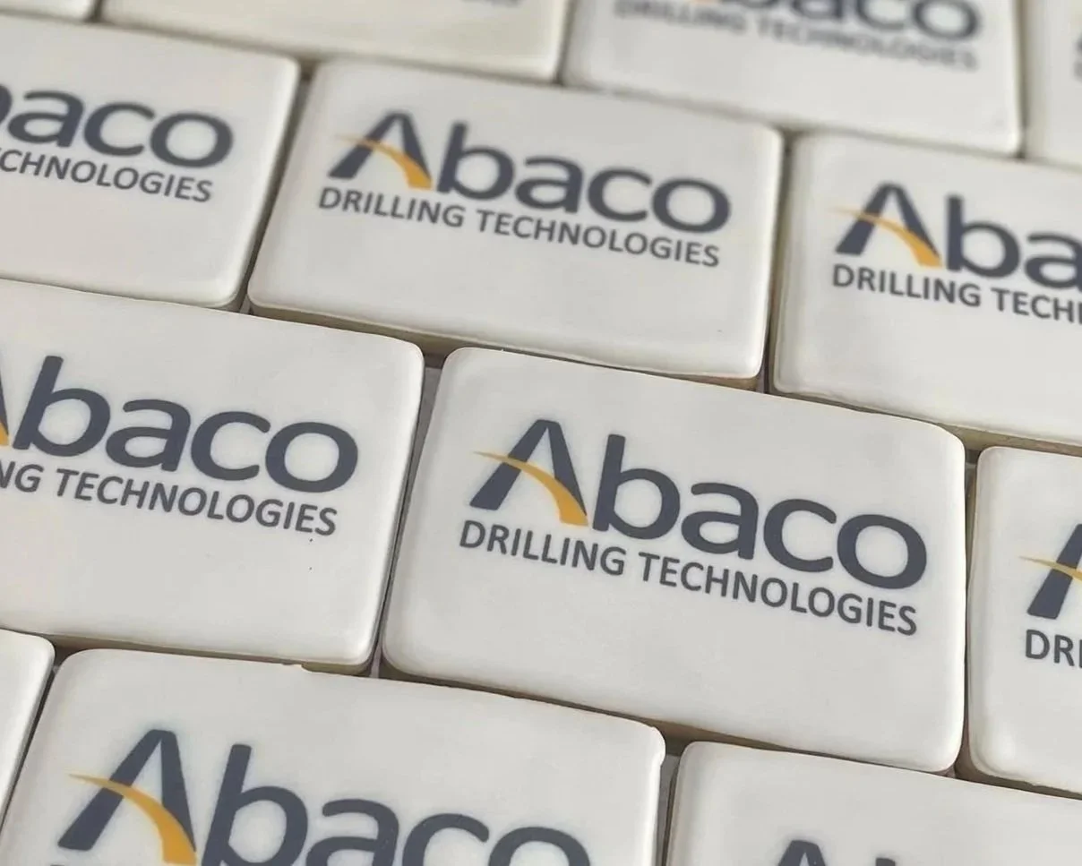 Close-up of white promotional tiles printed with the Abaco Drilling Technologies logo