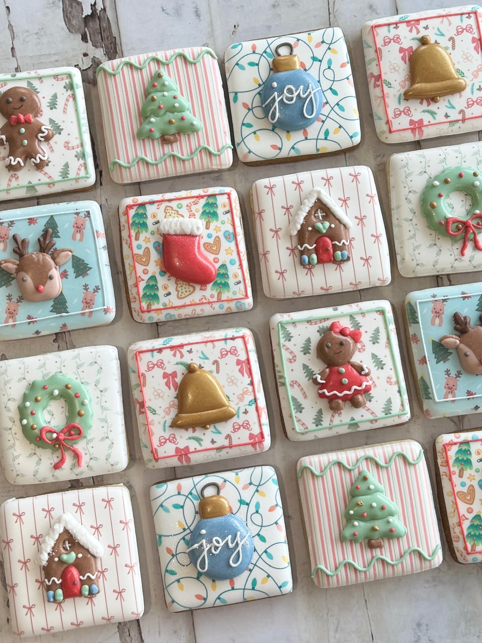 Assortment of festive Christmas cookies decorated as gingerbread people, trees, wreaths, stockings, bells, ornaments, and gingerbread houses.
