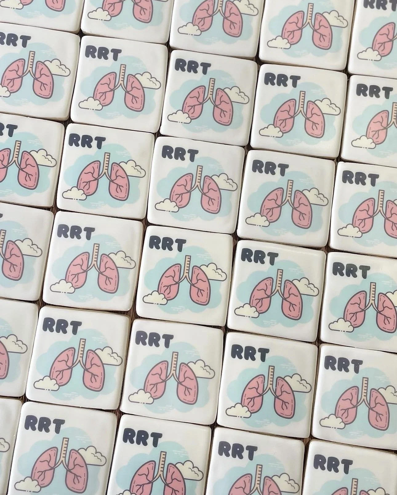 Rows of white tiles featuring pink lung illustrations, clouds, and the letters “RRT.”