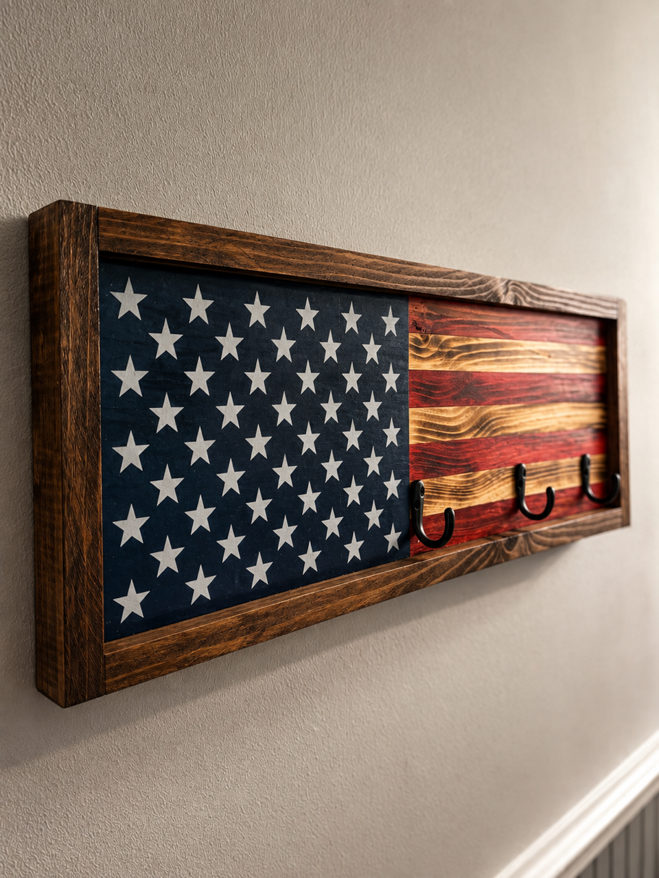 Wall-mounted wooden U.S. flag with hooks for hanging items.