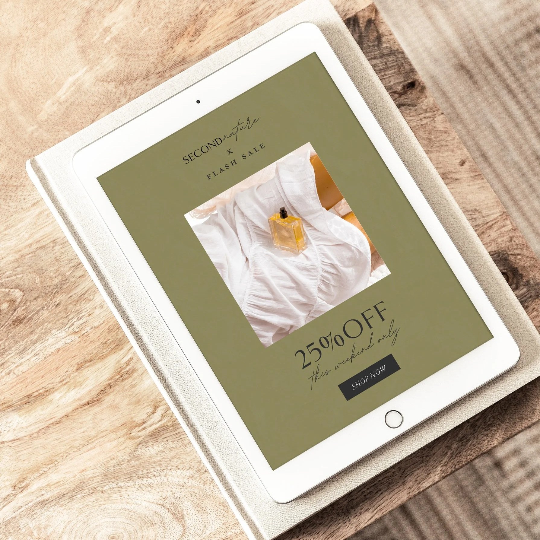 iPad on wooden table displaying an advertisement for a flash sale offering 25% to 50% off during the weekend.