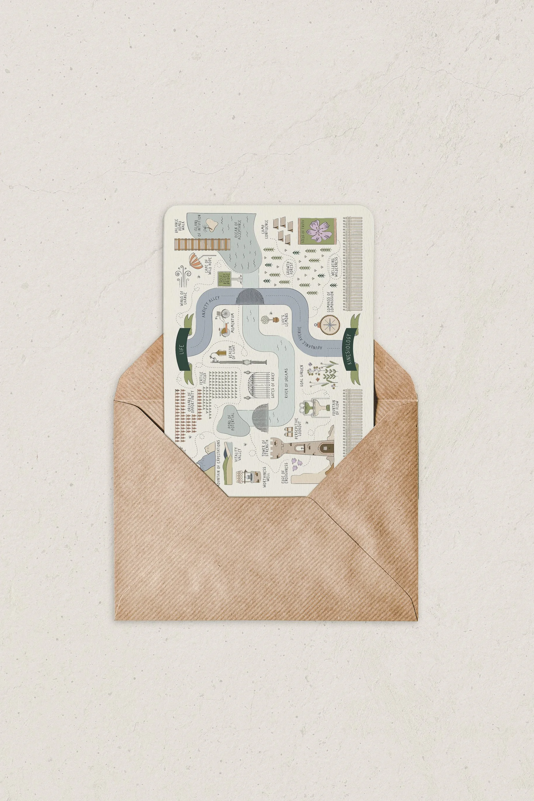 Open brown paper envelope containing a colorful illustrated trail map on a white surface.