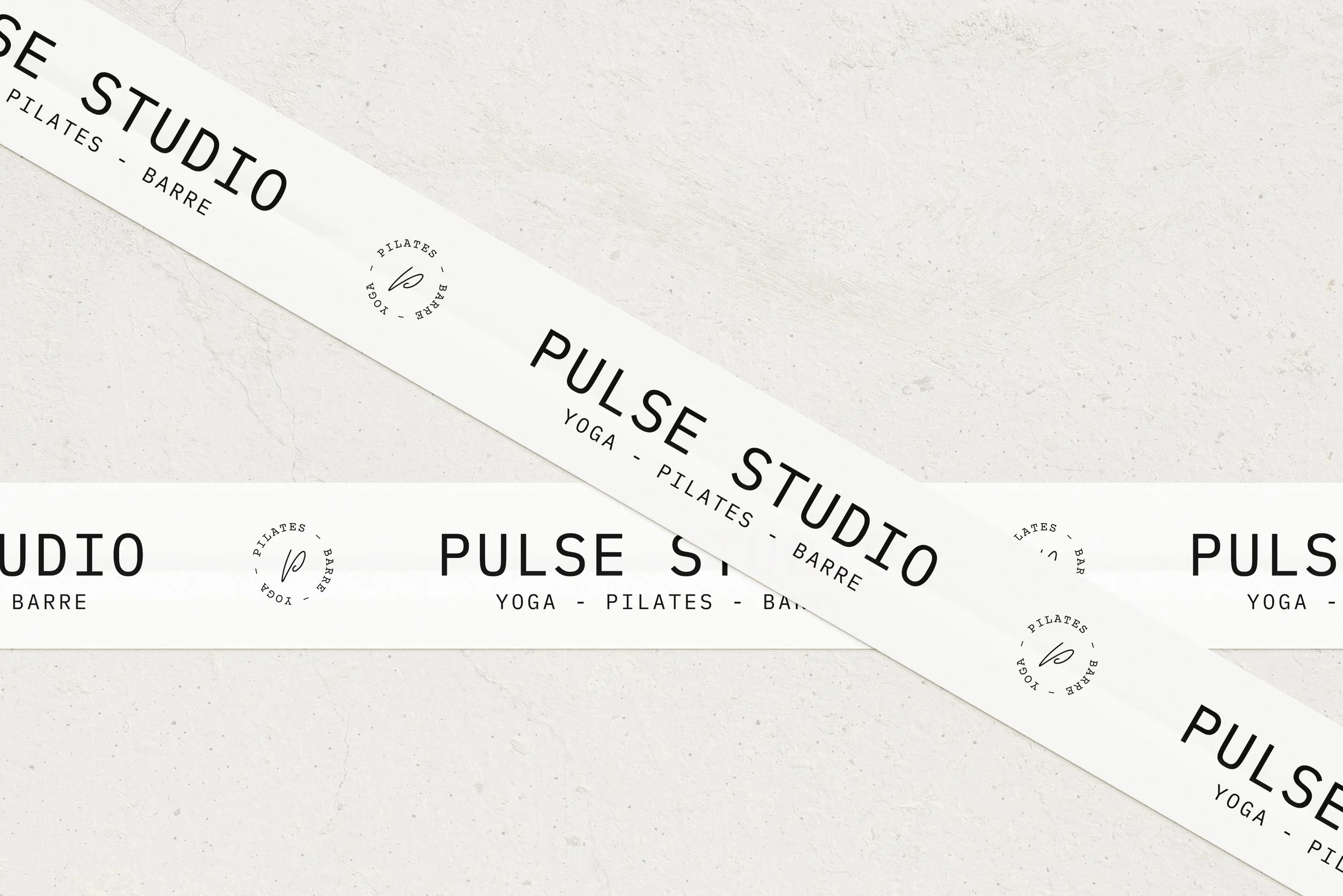 Multiple white stickers featuring black text and circular logo with a 'P' in the center. The stickers display the words 'PULSE STUDIO' and list activities such as yoga, pilates, barre, and their associated categories.