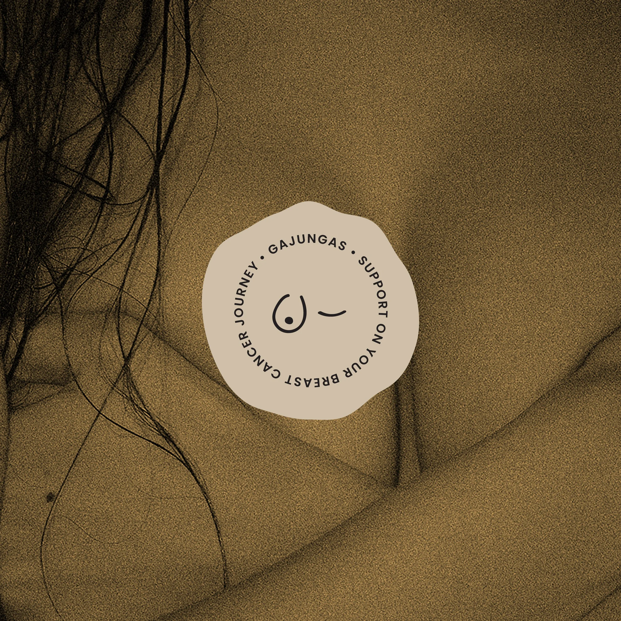 Close-up of a brown textured surface with black, tangled wires and a white circular sticker with black text.