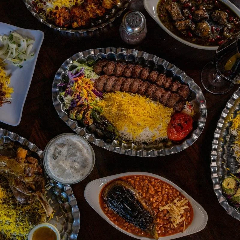 Traditional Persian dishes at Shiraz Persian Cuisine, including kababs, saffron rice, vegetables, and traditional sides.