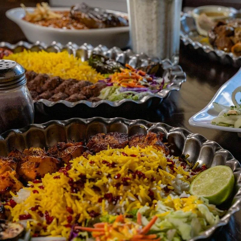 Persian kabab platter with saffron rice, grilled meat, vegetables, and lime at Shiraz Persian Cuisine.