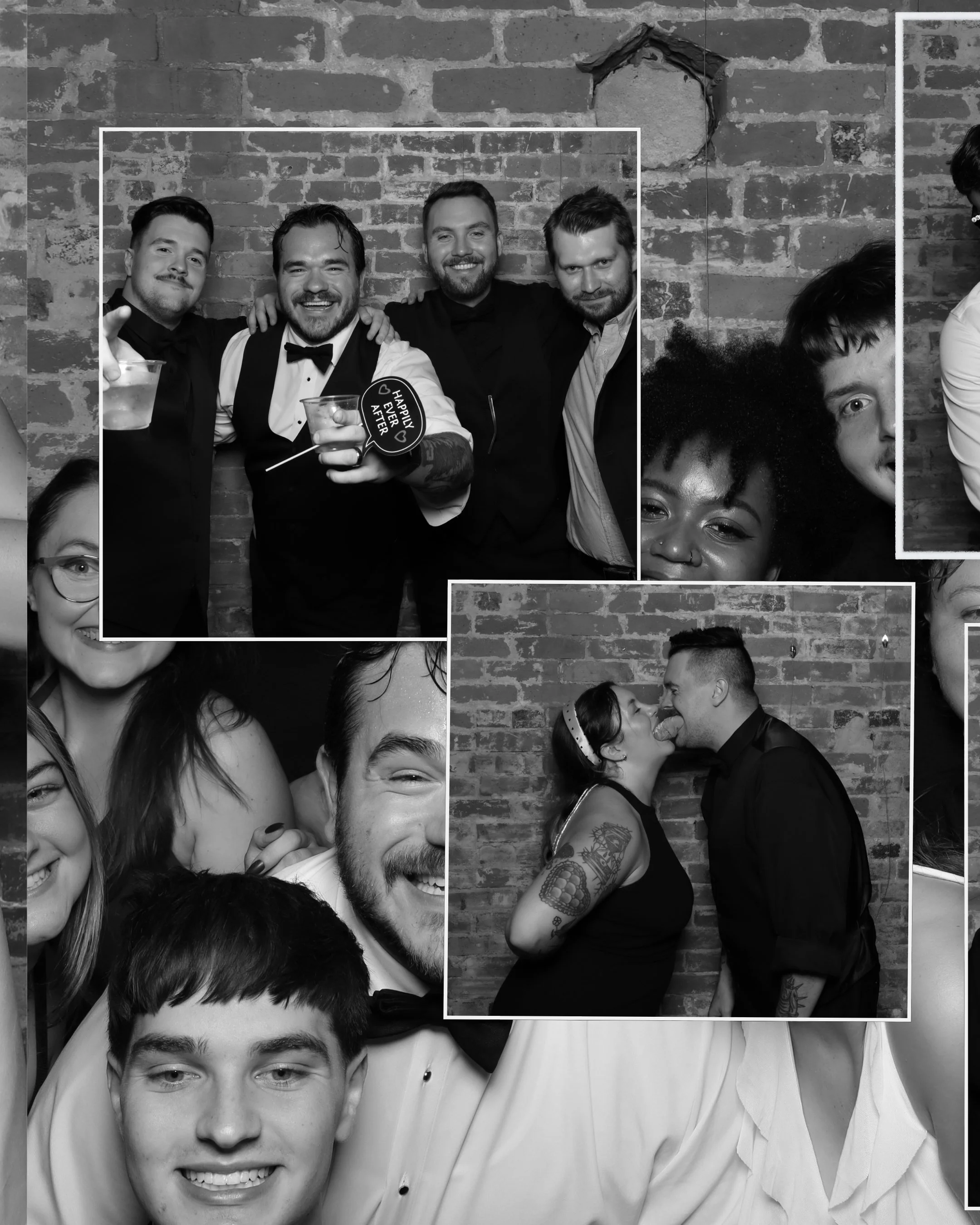 Black and white photo of a group of smiling friends at a party, holding drinks, against a brick wall background.