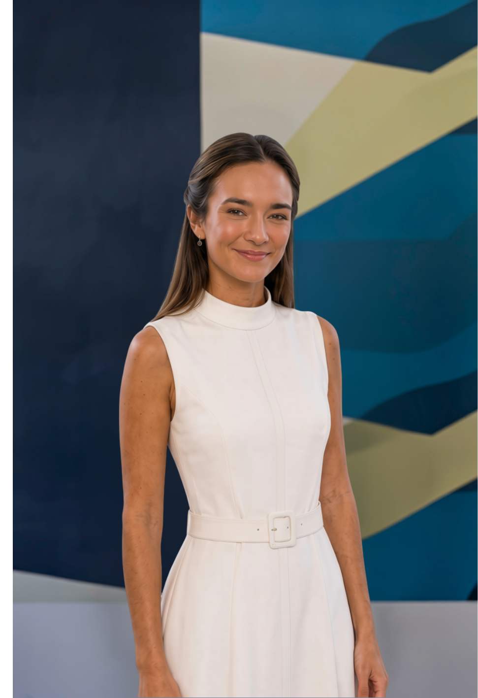 A woman with long brown hair, wearing a sleeveless white dress with a belt, standing in front of a colorful geometric mural background.