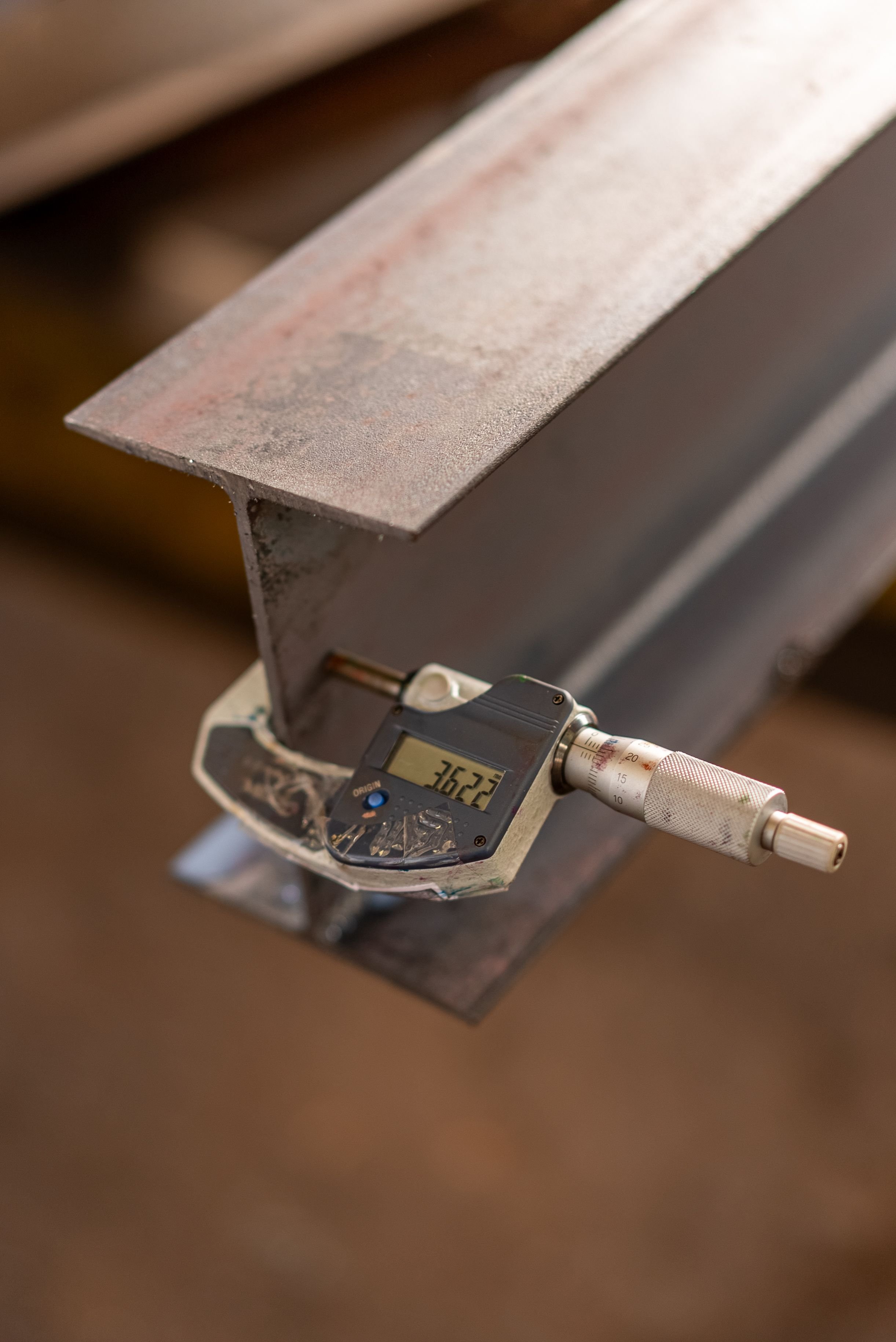 Close-up of a digital dial scale measuring a metallic object, showing 362.3 grams.
