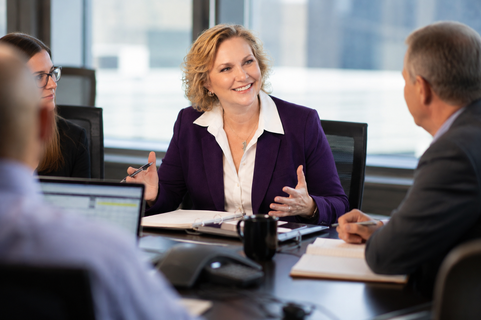 Susan Polk in a strategy meeting with a client team, discussing marketing positioning and next steps