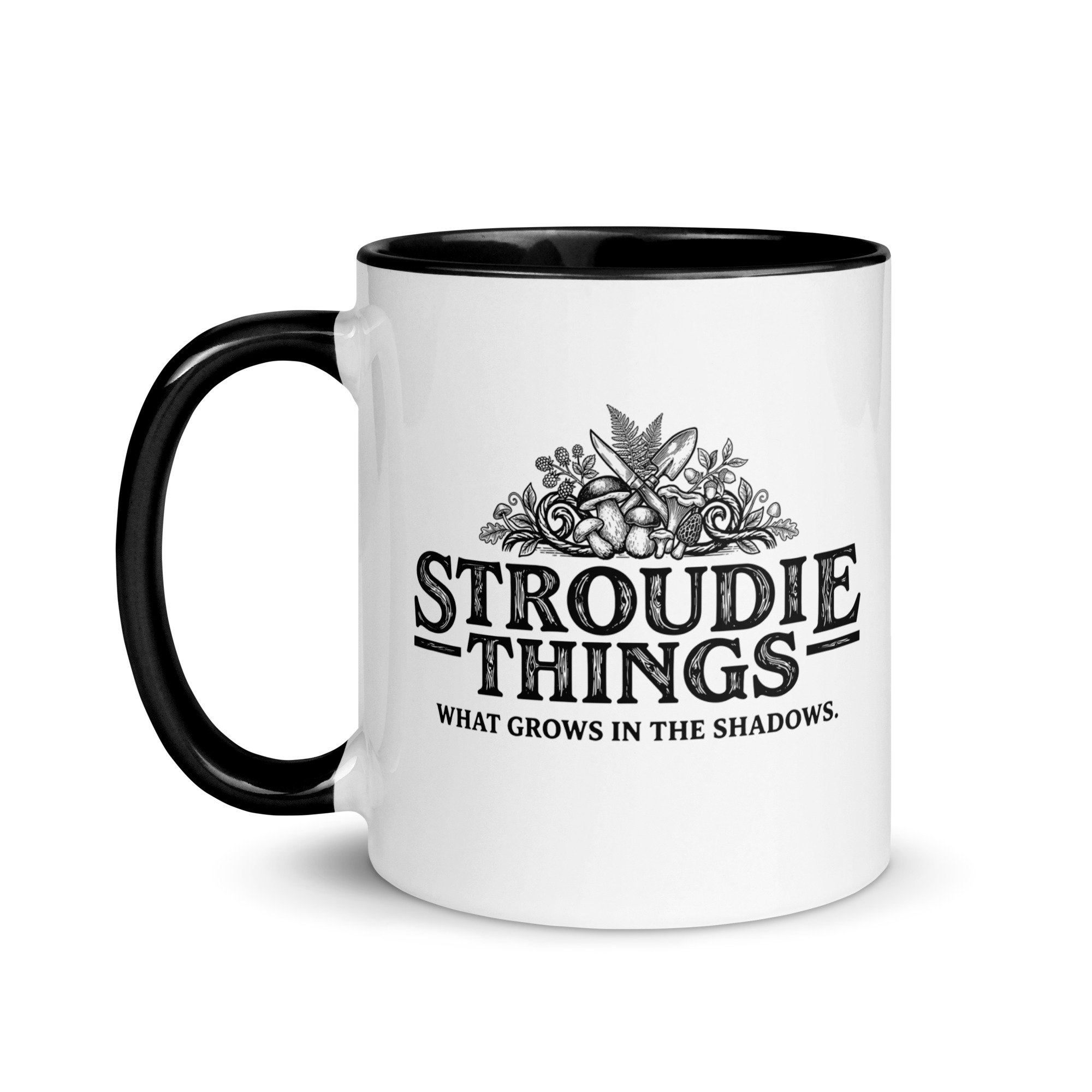 Stroudie Things ceramic mug with black handle featuring mushroom and fern woodcut style illustration