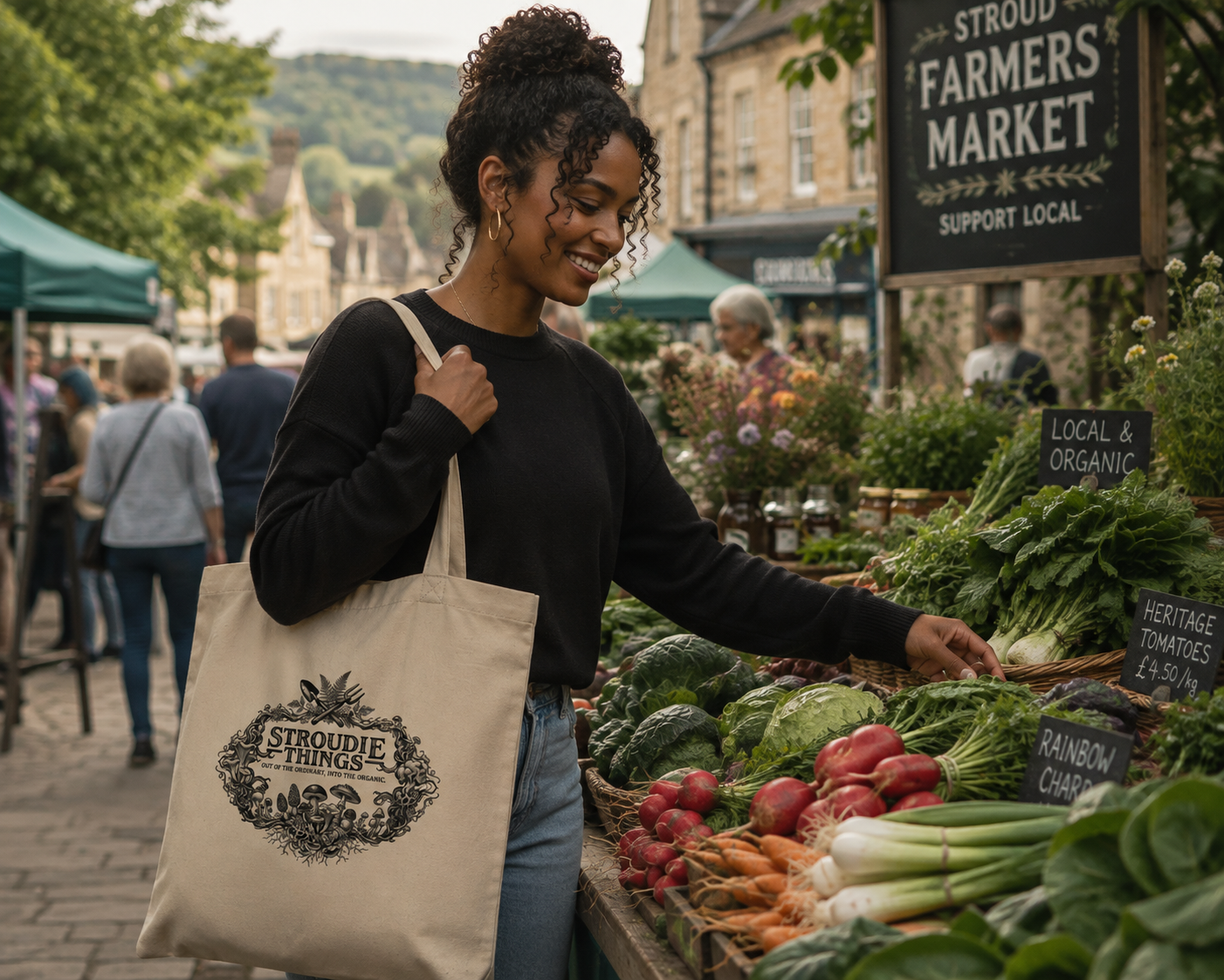 Woman shopping at Stroud Farmers Market carrying a Stroudie Things organic tote bag.