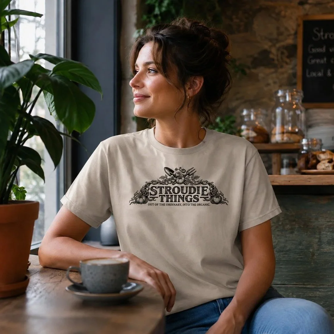 stroudie-things-out-of-the-ordinary-organic-cotton-t-shirt-worn-by-female-enjoying-coffee-in-cafe