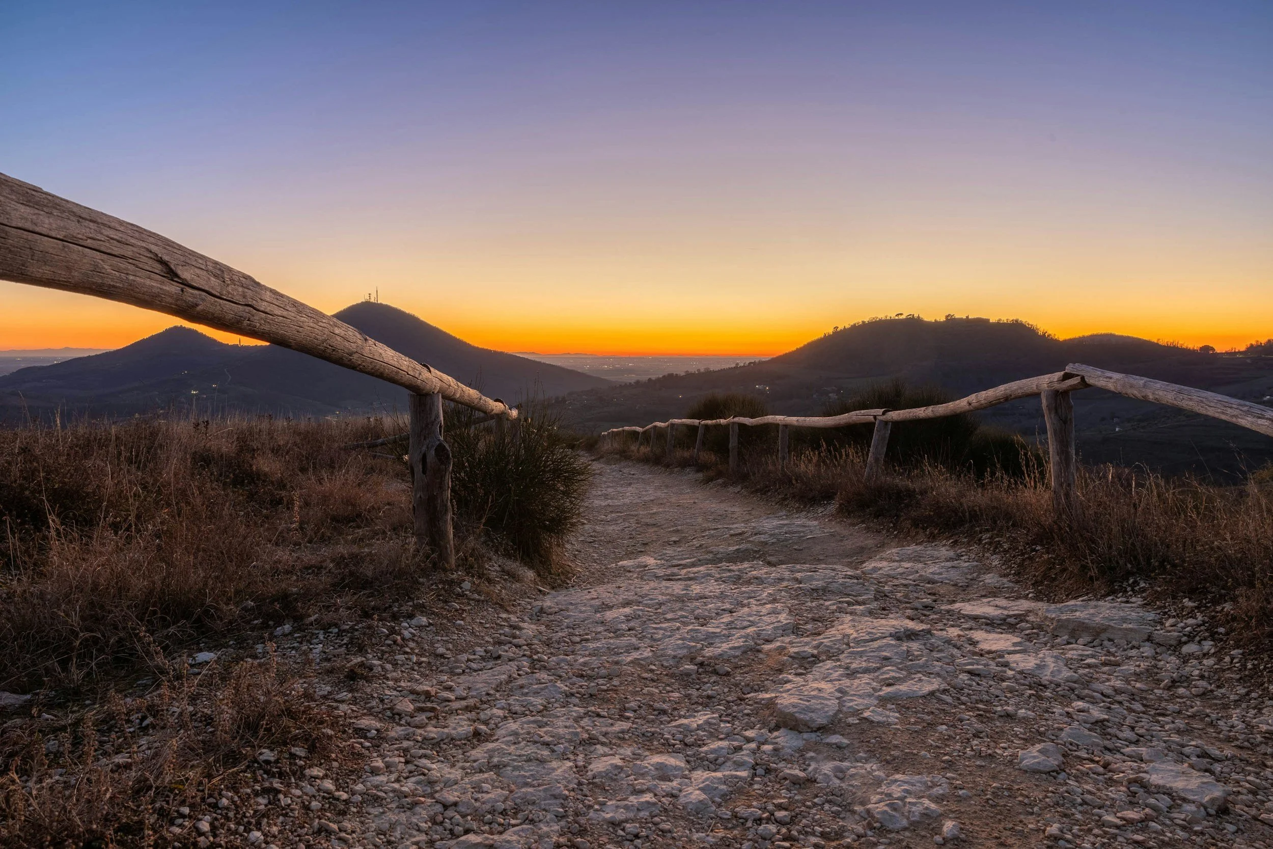 Scenic dirt trail at sunset overlooking the Euganean Hills landscape near Padova.