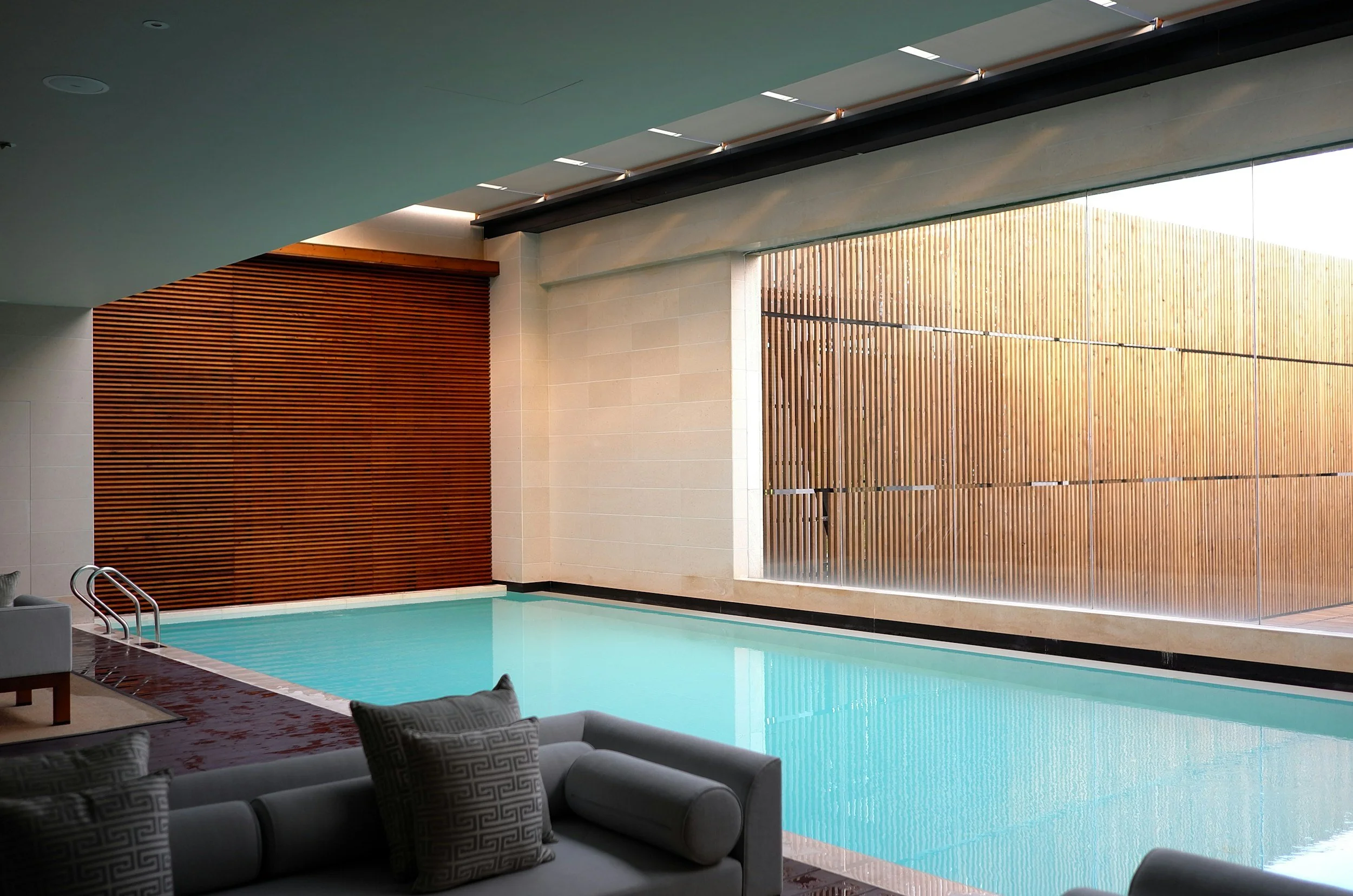 Indoor luxury swimming pool and lounge seating for the monthly spa day activity.
