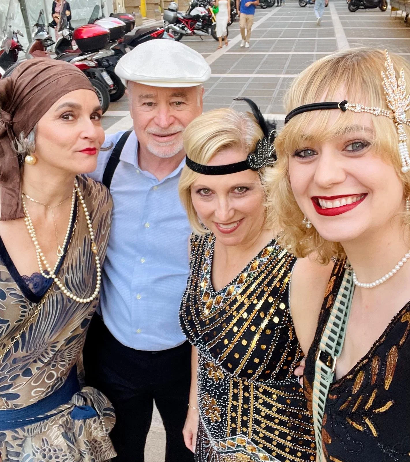 Group selfie of members in retro 1920s outfits and hats.