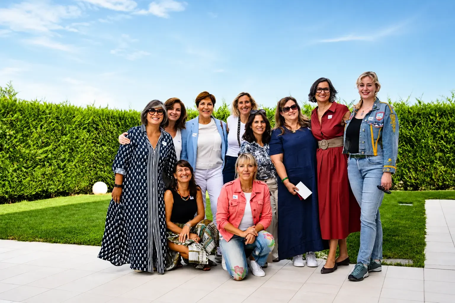 Multicultural group of expat and local women smiling together outdoors in Padova.