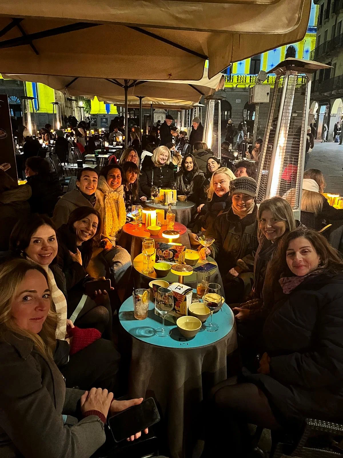 Group of women enjoying drinks outdoors at night during a spritz evening in Padova.