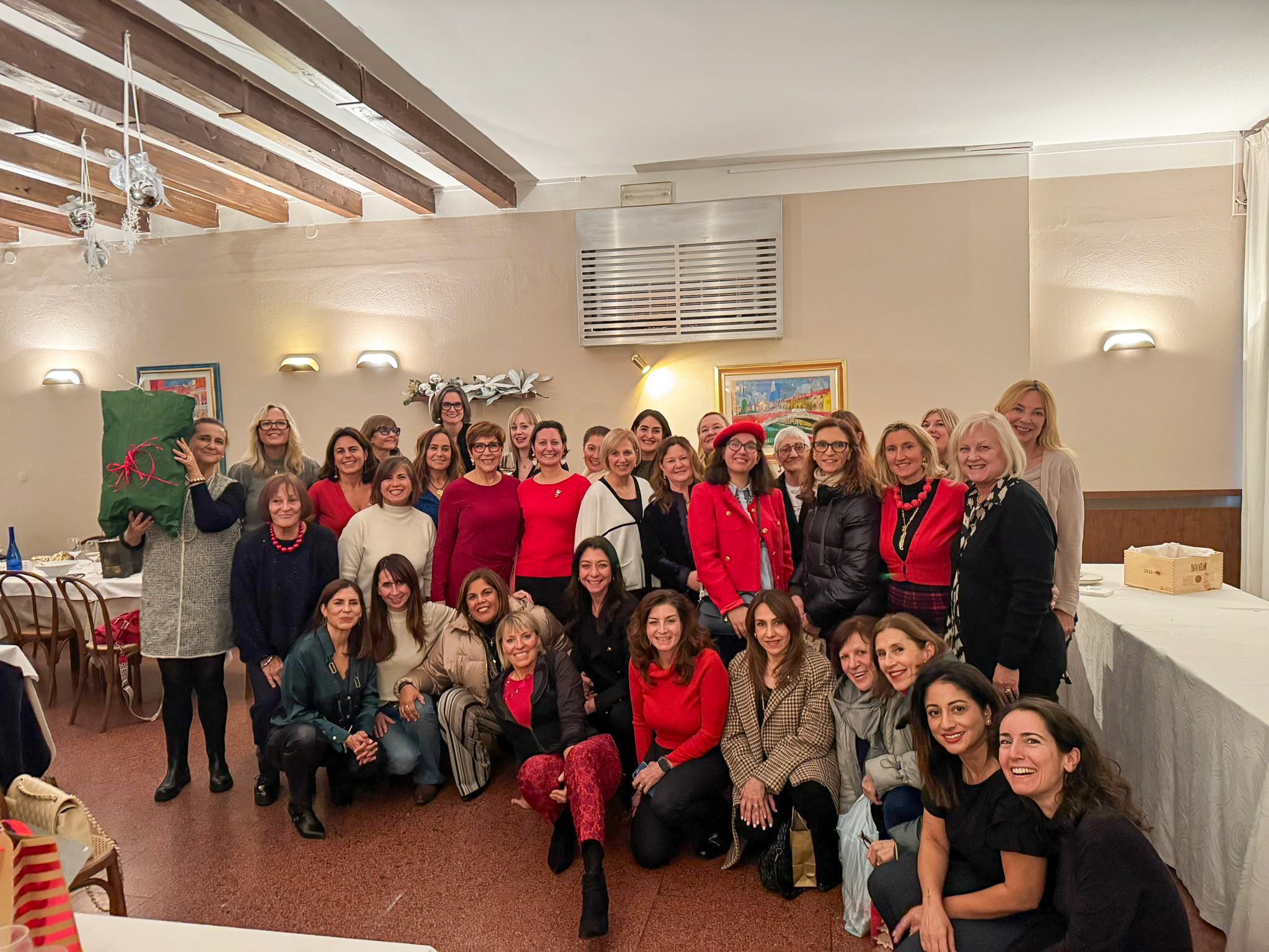Large group of International Ladies Group of Padova members posing together indoors.