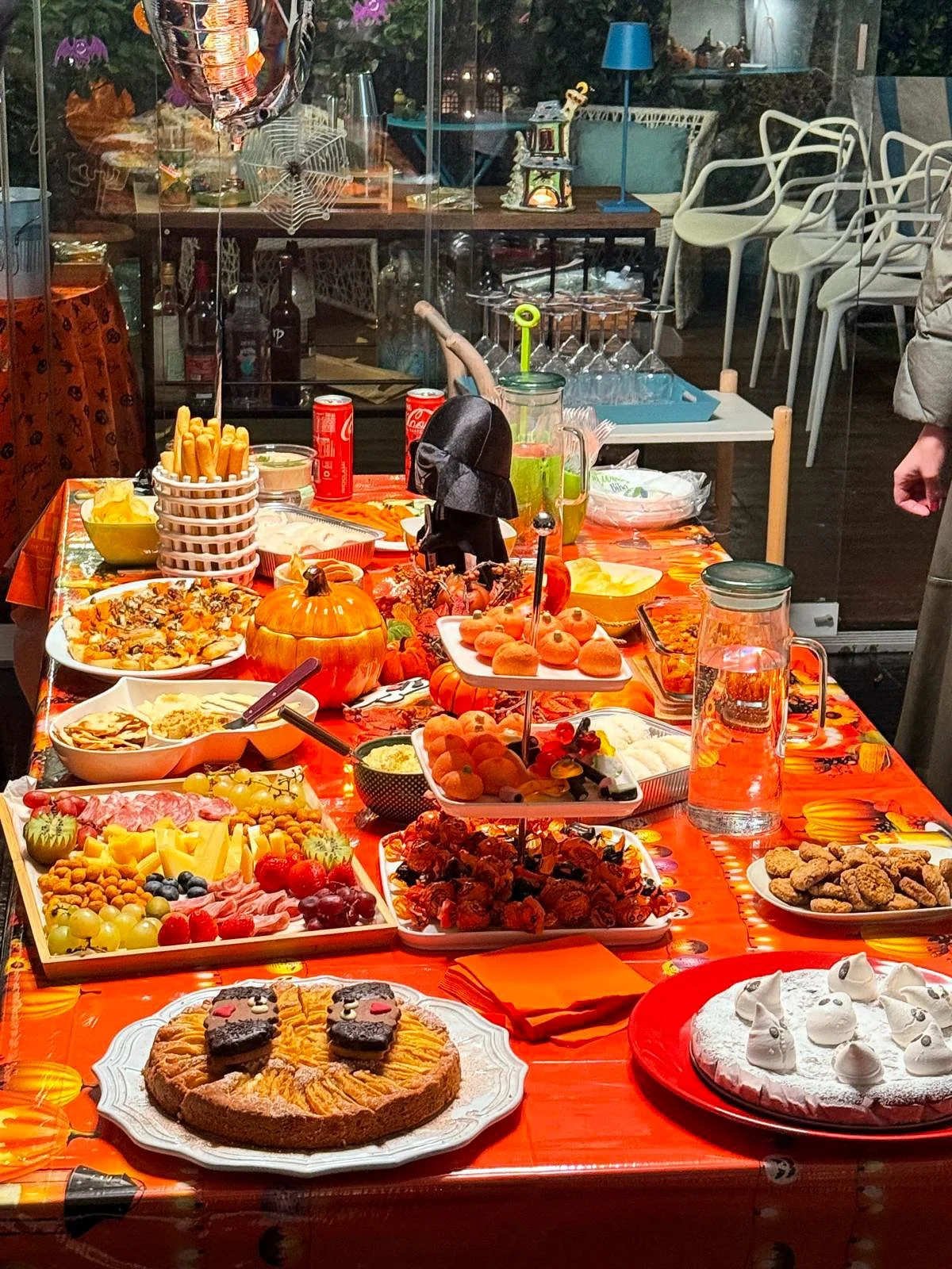 Festive Halloween buffet table decorated with pumpkins and treats.