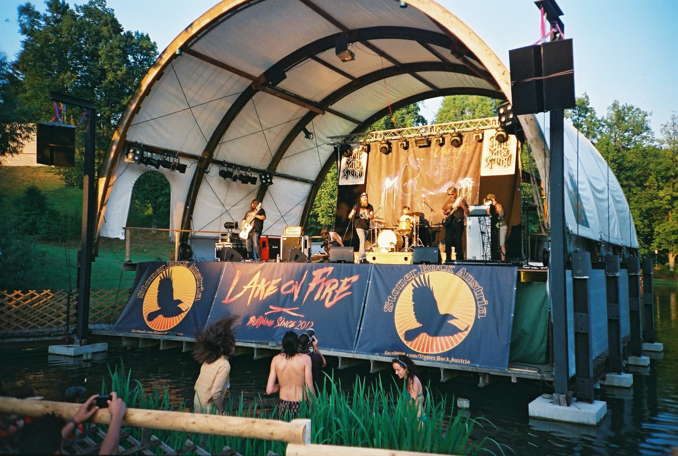 Lake on Fire Festival stage featuring the illustrated Lake on Fire 2015 branding and backdrop.