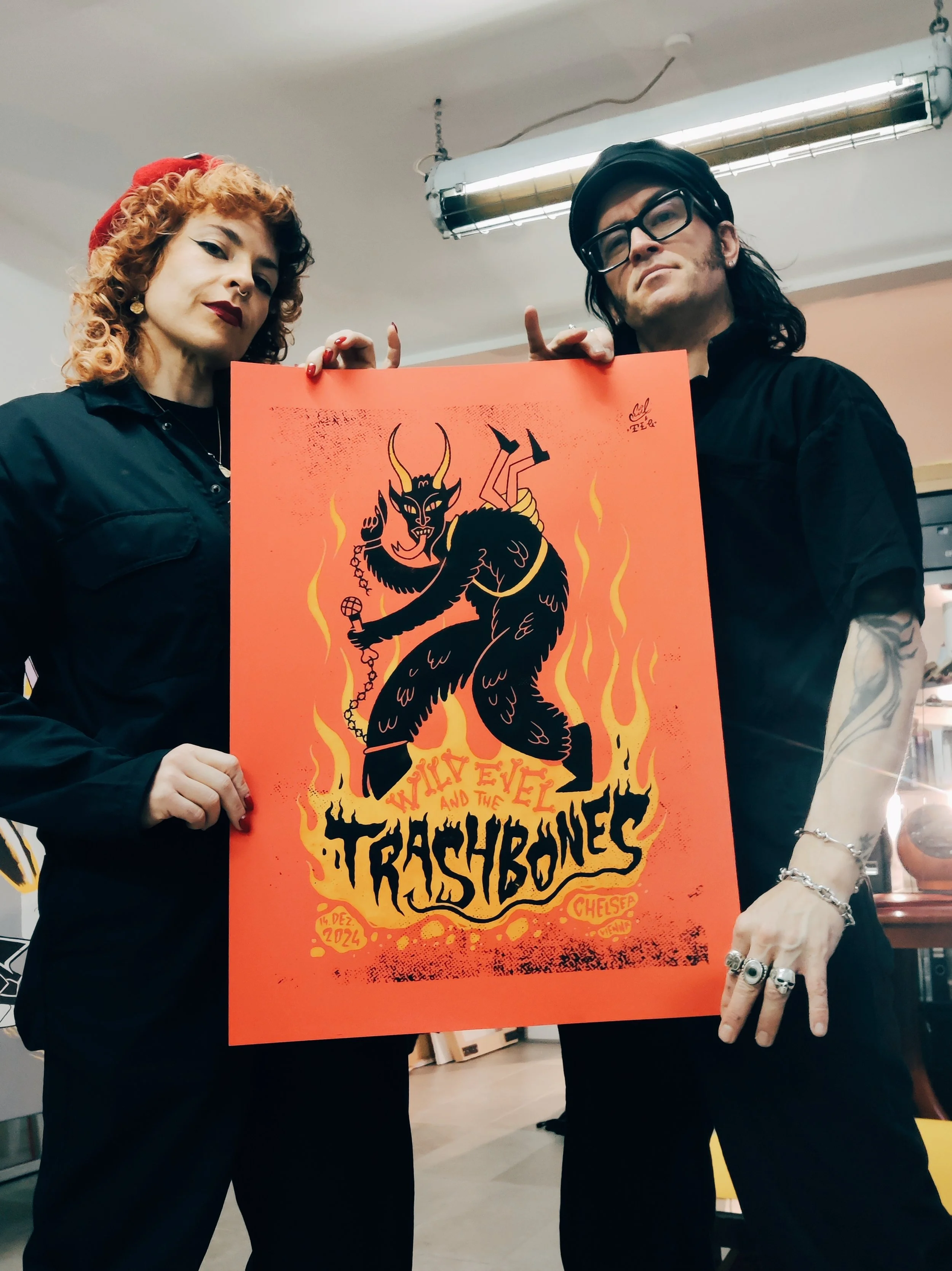 Constanze Baumfrisch and Wild Evel holding the finished two-colour Krampus screen print poster.