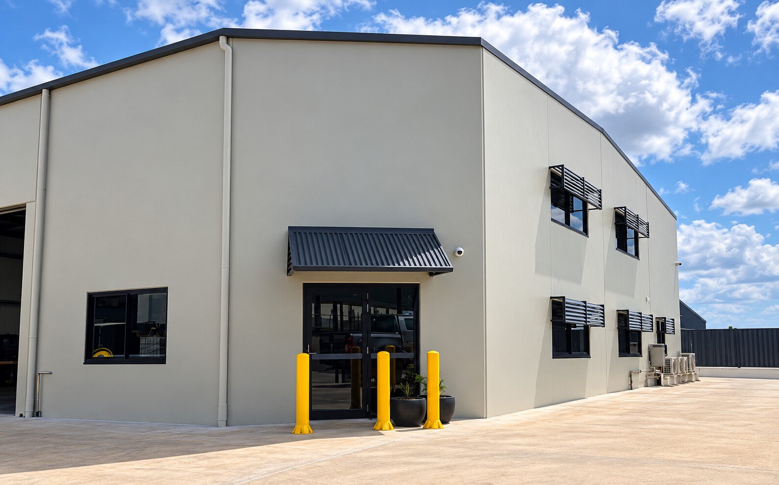 Completed commercial shed exterior with a covered entrance