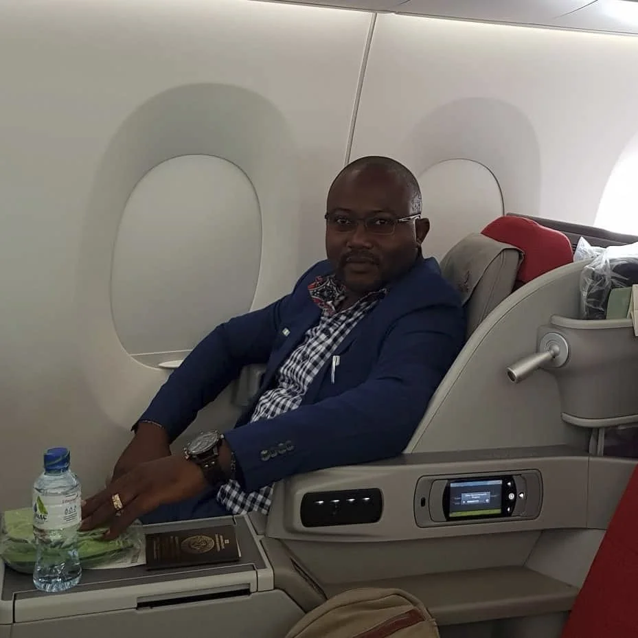 Image of a man seated in a plane.